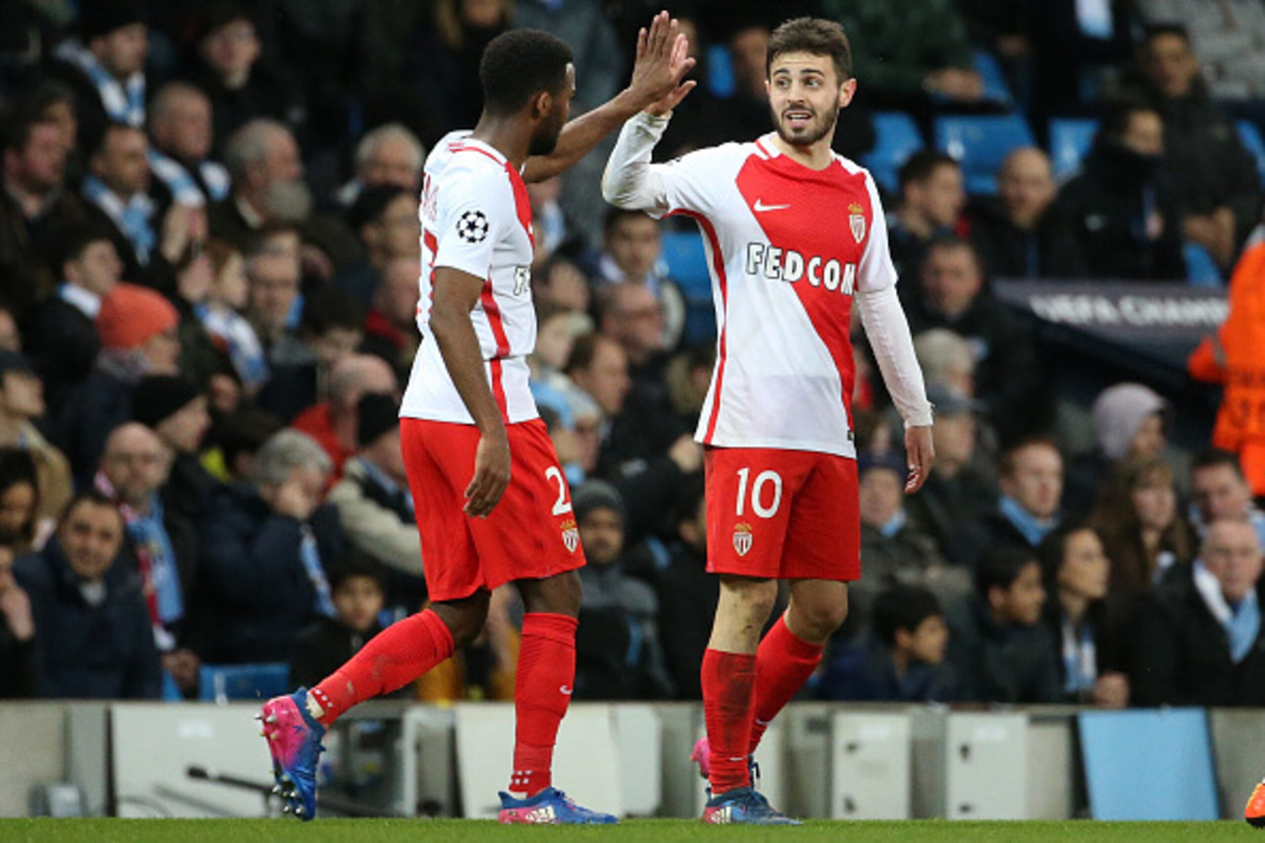 MANCHESTER, ENGLAND - FEBRUARY 21: Thomas Lemar of Monaco greets teammate Bernardo Silva after a goal during the UEFA Champions League Round of 16 first leg match between Manchester City FC and AS Monaco at Etihad Stadium on February 21, 2017 in Mancheste