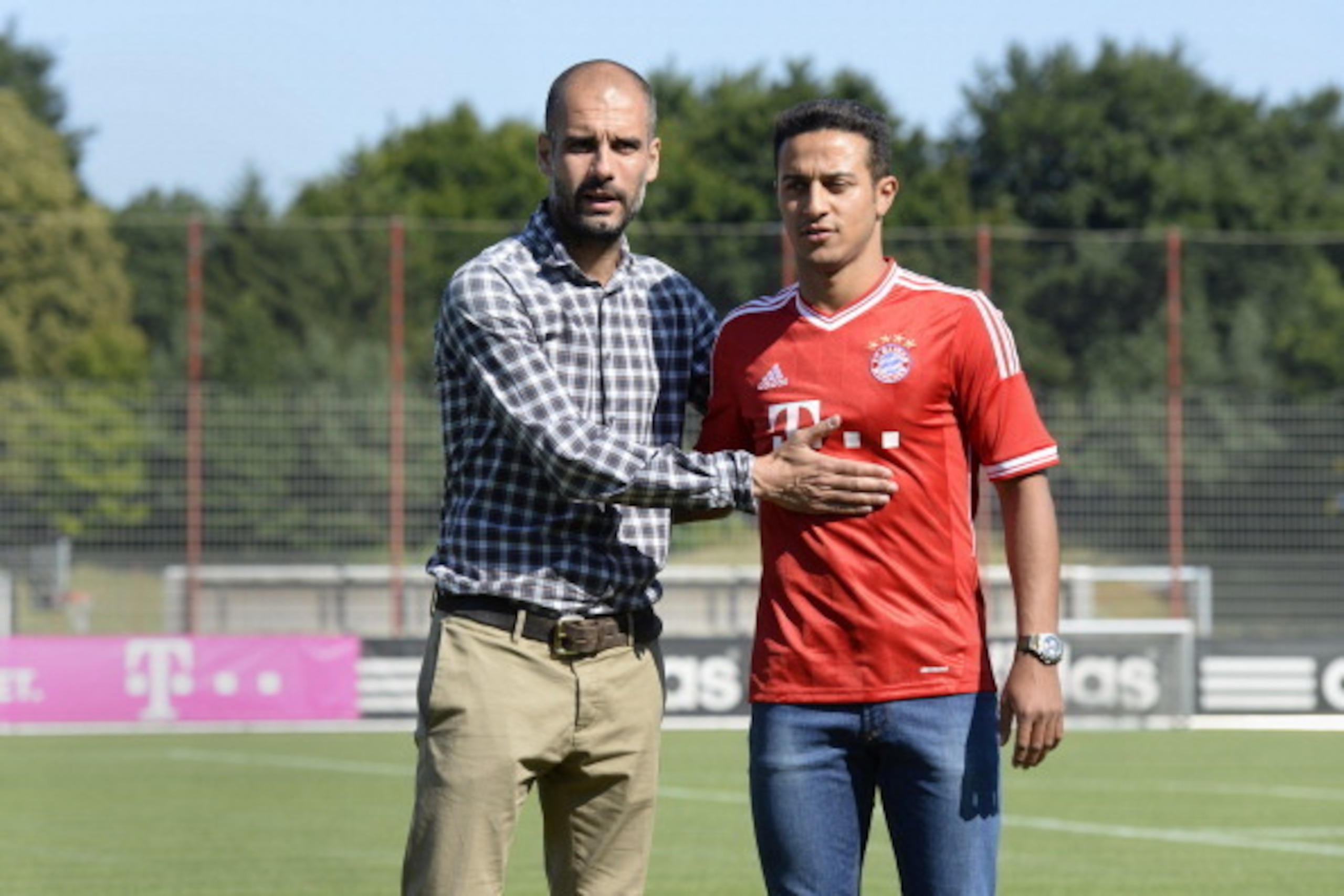 Bayern Munich's Spanish headcoach Pep Guardiola (L) presents Bayern Munich's new Spanish midfielder Thiago Alcantara at their training grounds in Munich, southern Germany, on July 16, 2013. Bayern Munich's latest signing Thiago Alcantara has revealed that
