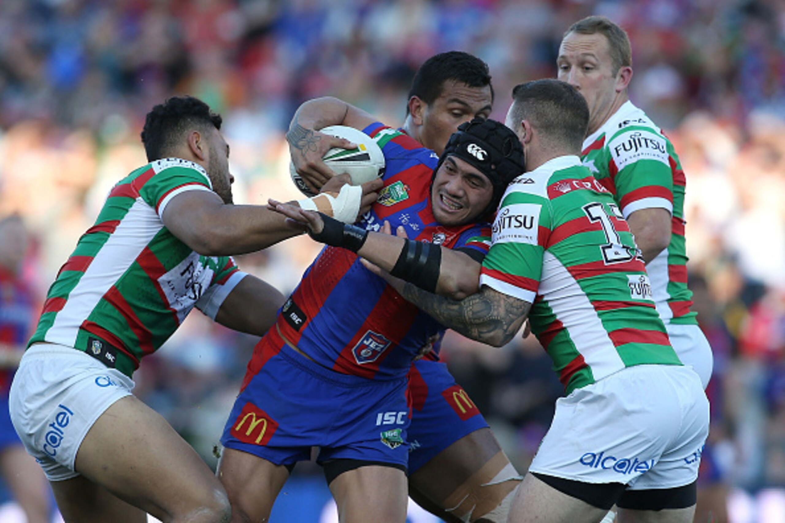 NEWCASTLE, AUSTRALIA - AUGUST 28:  Sione Mata'Utia of the Knights is tackled by the Rabbitohs defence during the round 25 NRL match between the Newcastle Knights and the South Sydney Rabbitohs at Hunter Stadium on August 28, 2016 in Newcastle, Australia. 