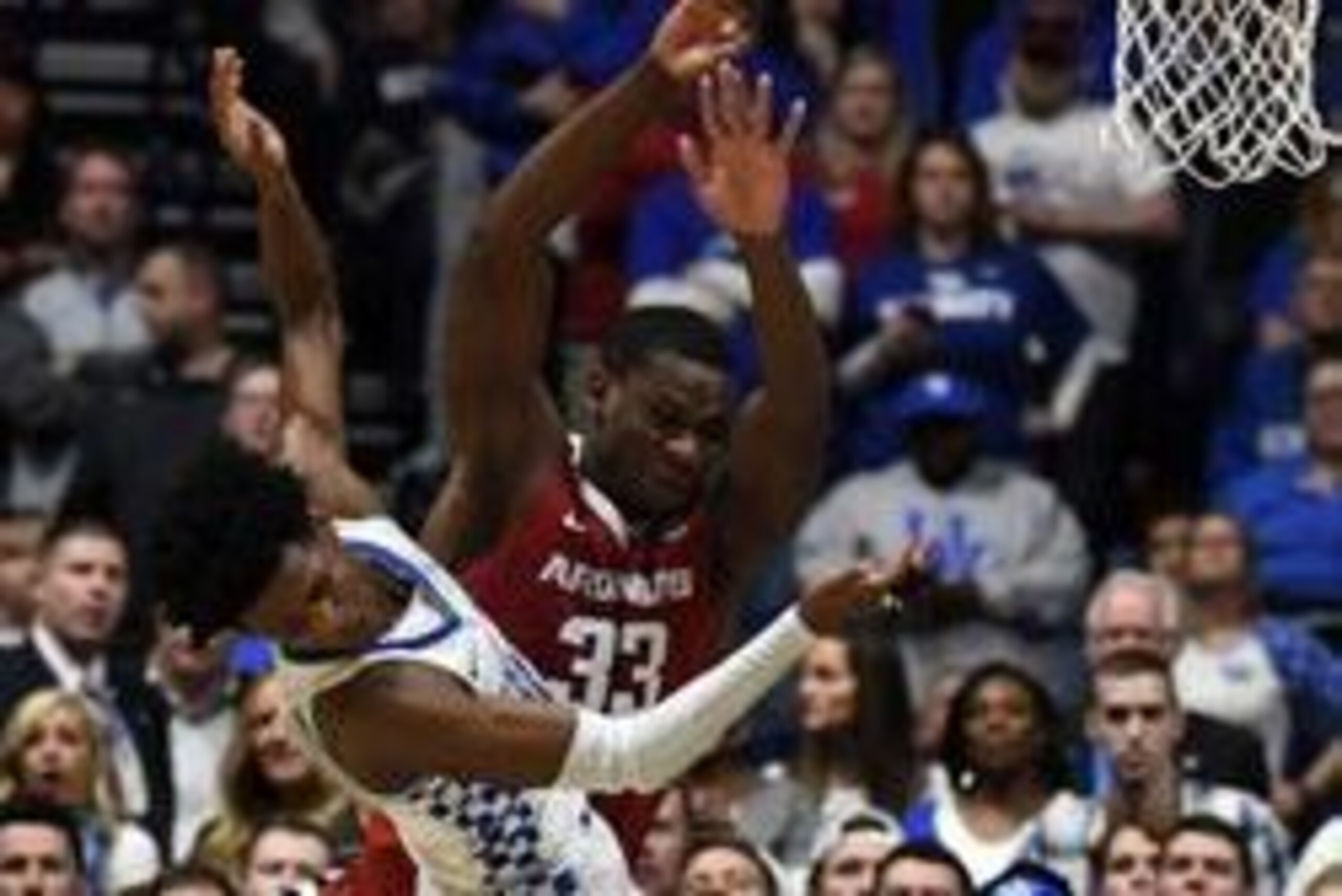 Mar 12, 2017; Nashville, TN, USA; Kentucky Wildcats guard De'Aaron Fox (0) is fouled by Arkansas Razorbacks forward Moses Kingsley (33) on a shot attempt during the second half during the SEC Conference Tournament at Bridgestone Arena. Kentucky won 82-65.