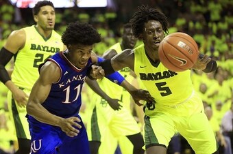 WACO, TX - FEBRUARY 18: Josh Jackson #11 of the Kansas Jayhawks and Johnathan Motley #5 of the Baylor Bears compete for a loose ball in the second half at the Ferrell Center on February 18, 2017 in Waco, Texas. Kansas won 67-65. (Photo by Ron Jenkins/Gett