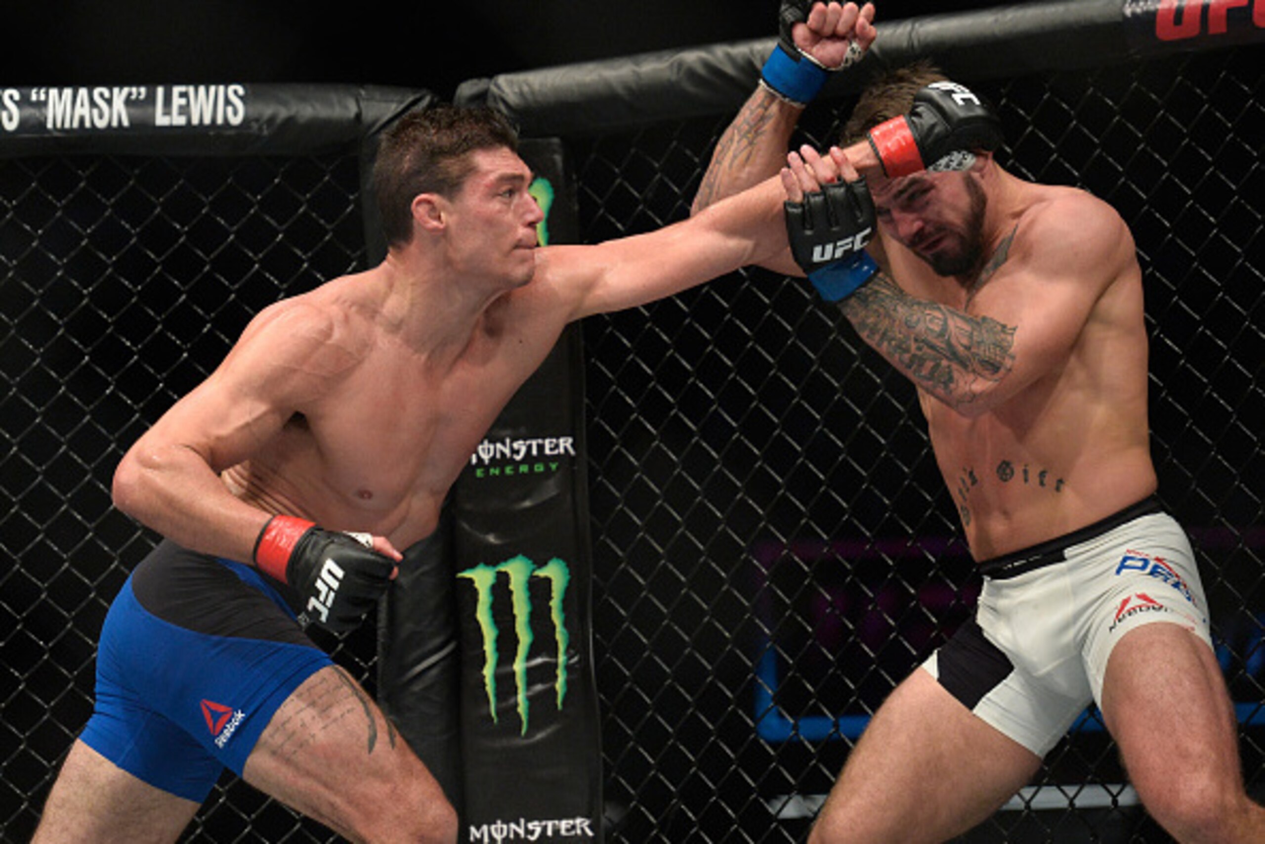SACRAMENTO, CA - DECEMBER 17:  (L-R) Alan Jouban punches Mike Perry in their welterweight bout during the UFC Fight Night event inside the Golden 1 Center Arena on December 17, 2016 in Sacramento, California. (Photo by Brandon Magnus/Zuffa LLC/Zuffa LLC v