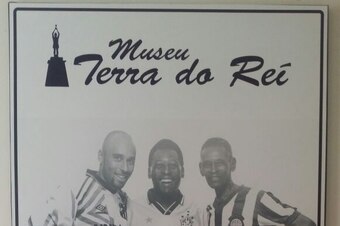 A poster of Edinho (left), Pele and Pele's father Dondinho, with each portrayed in their playing days