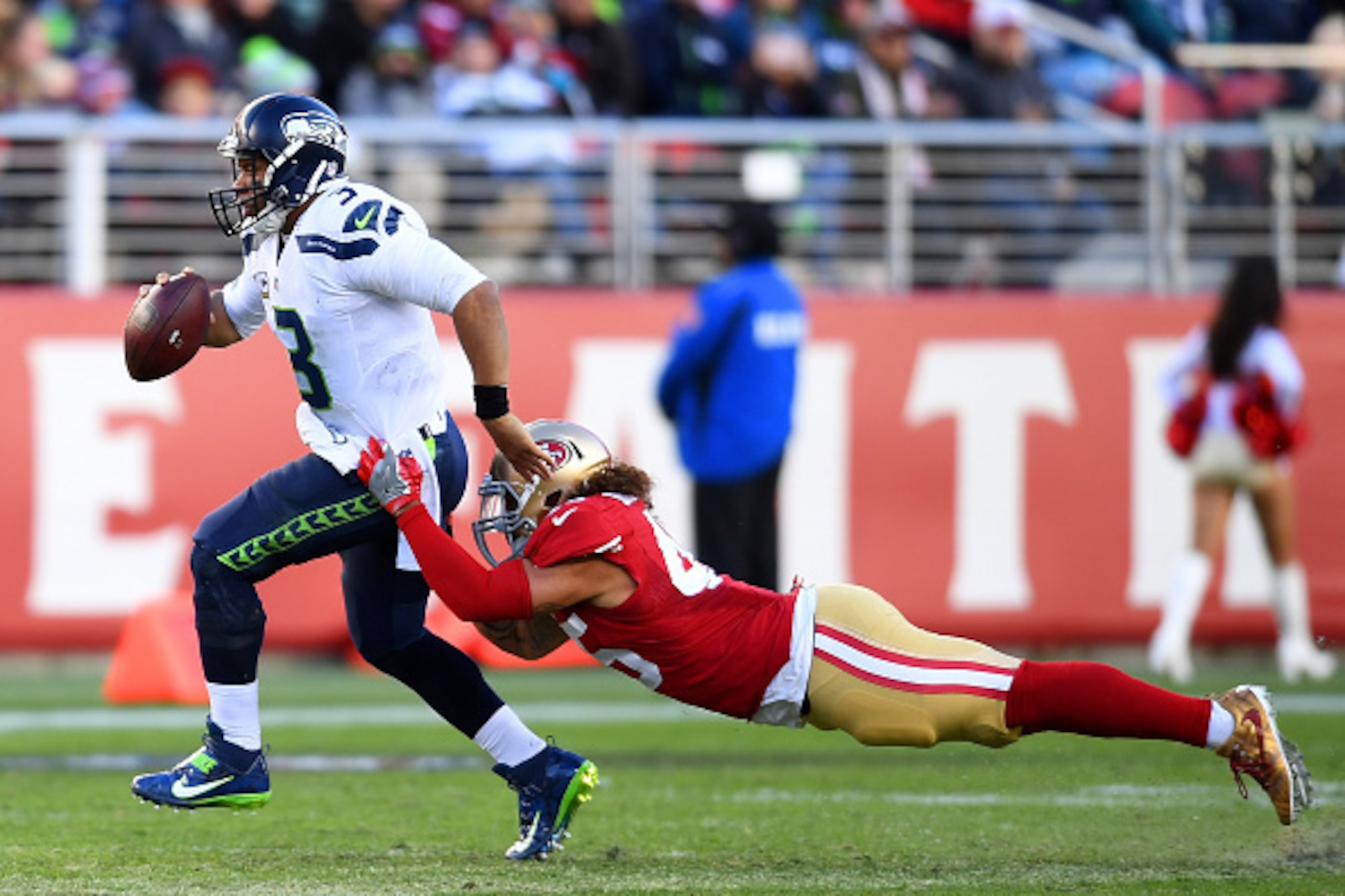 SANTA CLARA, CA - JANUARY 01:  Russell Wilson #3 of the Seattle Seahawks looks to get his pass off under pressure from Carl Bradford #45 of the San Francisco 49ers during the third quarter of their NFL football game at Levi's Stadium on January 1, 2017 in