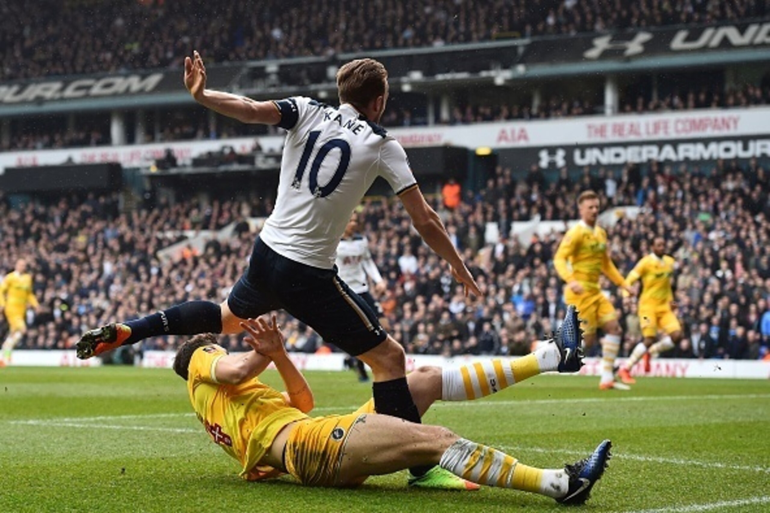 Tottenham Hotspur's English striker Harry Kane is tackled by Millwall's English defender Jake Cooper as he shoots at goal during the English FA Cup quarter-final football match between Tottenham Hotspur and Millwall at White Hart Lane in London, on March 