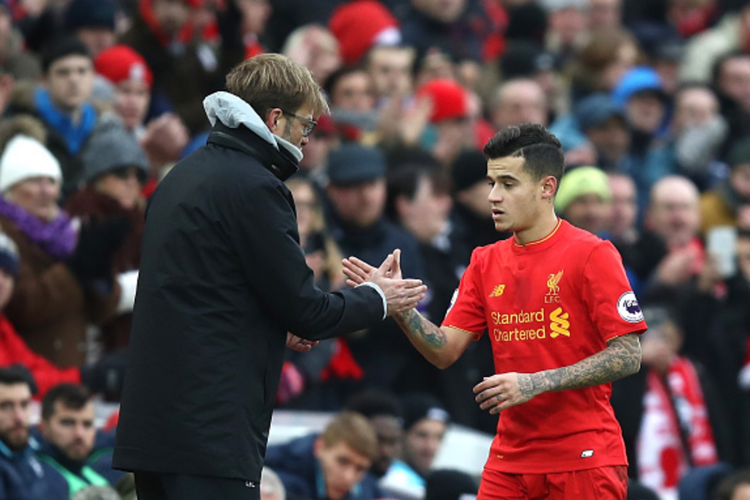 LIVERPOOL, ENGLAND - JANUARY 21: Jurgen Klopp, Manager of Liverpool (L) and Philippe Coutinho of Liverpool (R) shake hands after he is subbed off during the Premier League match between Liverpool and Swansea City at Anfield on January 21, 2017 in Liverpoo
