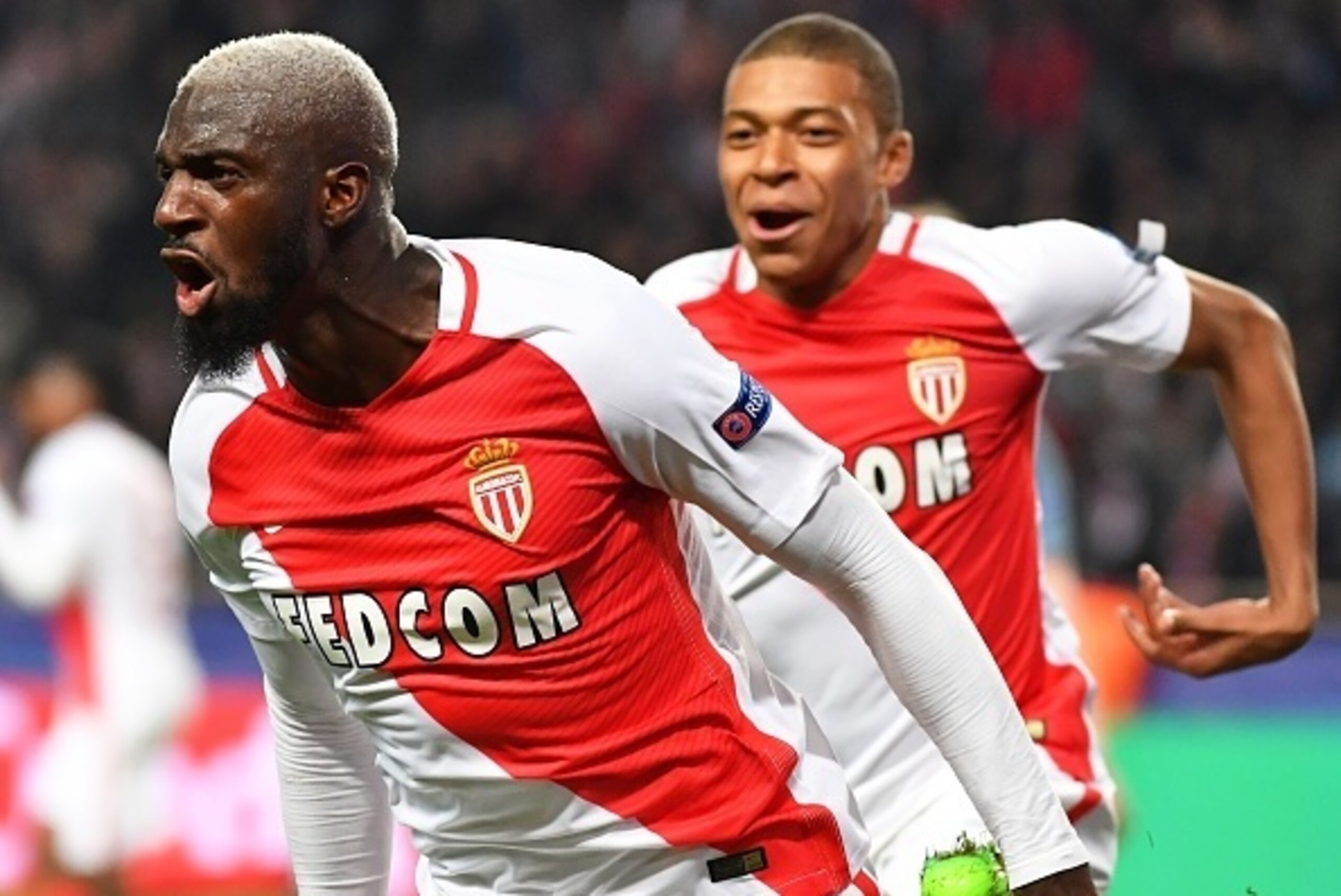 Monaco's French midfielder Tiemoue Bakayoko celebrates with Monaco's French forward Kylian Mbappe Lottin (back) after scoring a goal during the UEFA Champions League round of 16 football match between Monaco and Manchester City at the Stade Louis II in Mo