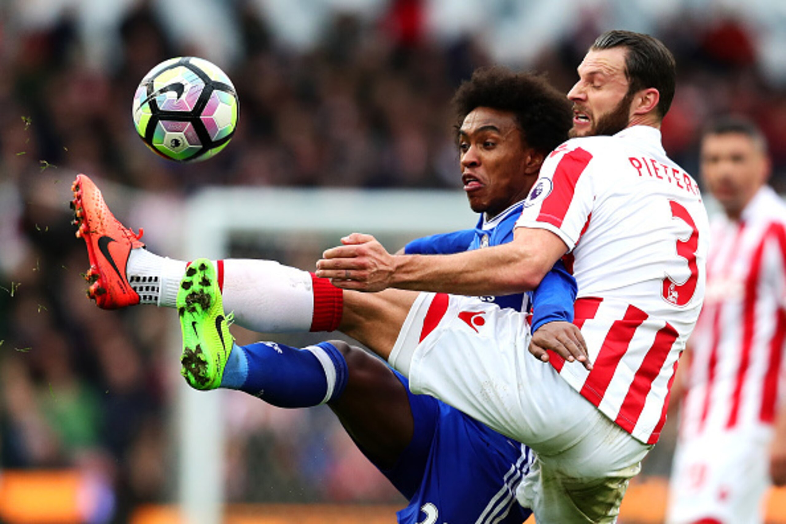 STOKE ON TRENT, ENGLAND - MARCH 18: Erik Pieters of Stoke City in action with Willian of Chelsea during the Premier League match between Stoke City and Chelsea at Bet365 Stadium on March 18, 2017 in Stoke on Trent, England. (Photo by Chris Brunskill Ltd/G