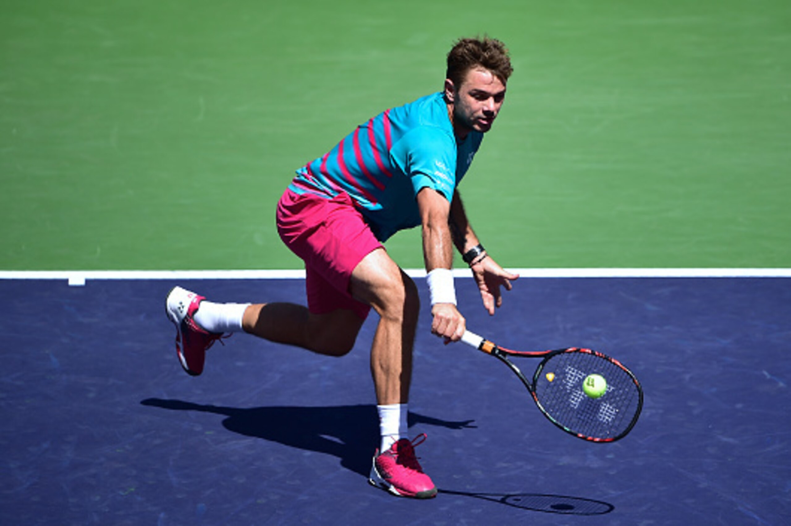 Stan Wawrinka of Switzerland hits a backhand return to Pablo Carreno Busta of Spain during their men's semifinal ATP Indian Wells Masters in Indian Wells, California on March 18, 2017, where Wawrinka defeated Busta 6-3, 6-2.  / AFP PHOTO / FREDERIC J. BRO