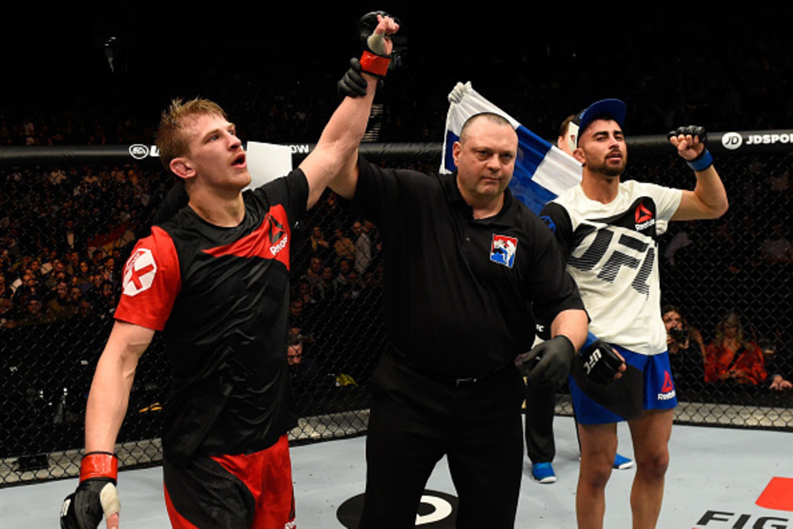 LONDON, ENGLAND - MARCH 18:  (L-R) Arnold Allen of England celebrates his victory over Makwan Amirkhani of Finland in their featherweight fight during the UFC Fight Night event at The O2 arena on March 18, 2017 in London, England. (Photo by Josh Hedges/Zu