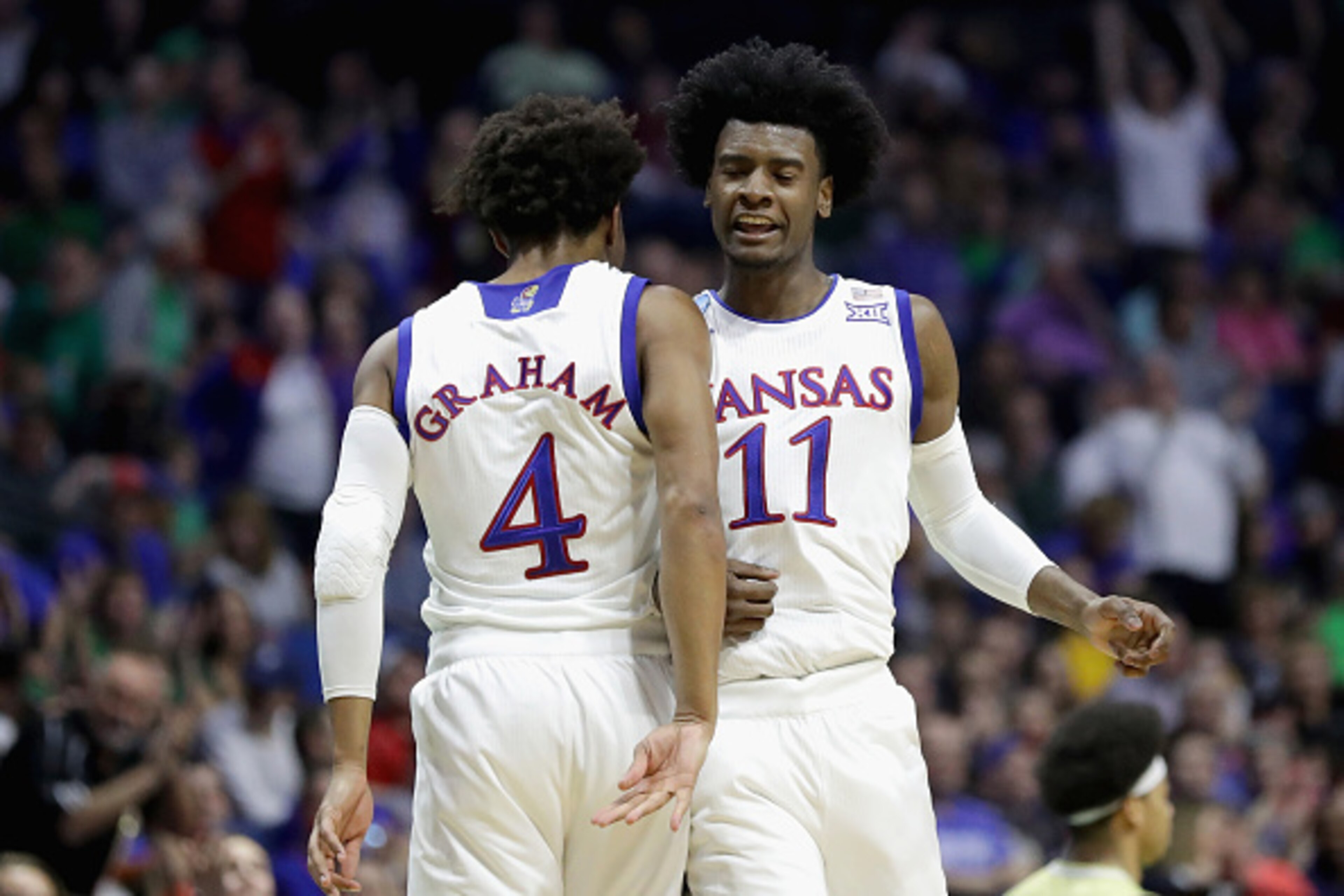 TULSA, OK - MARCH 17:  Teammates Devonte' Graham #4 and Josh Jackson #11 of the Kansas Jayhawks react against the UC Davis Aggies during the first round of the 2017 NCAA Men's Basketball Tournament at BOK Center on March 17, 2017 in Tulsa, Oklahoma.  (Pho