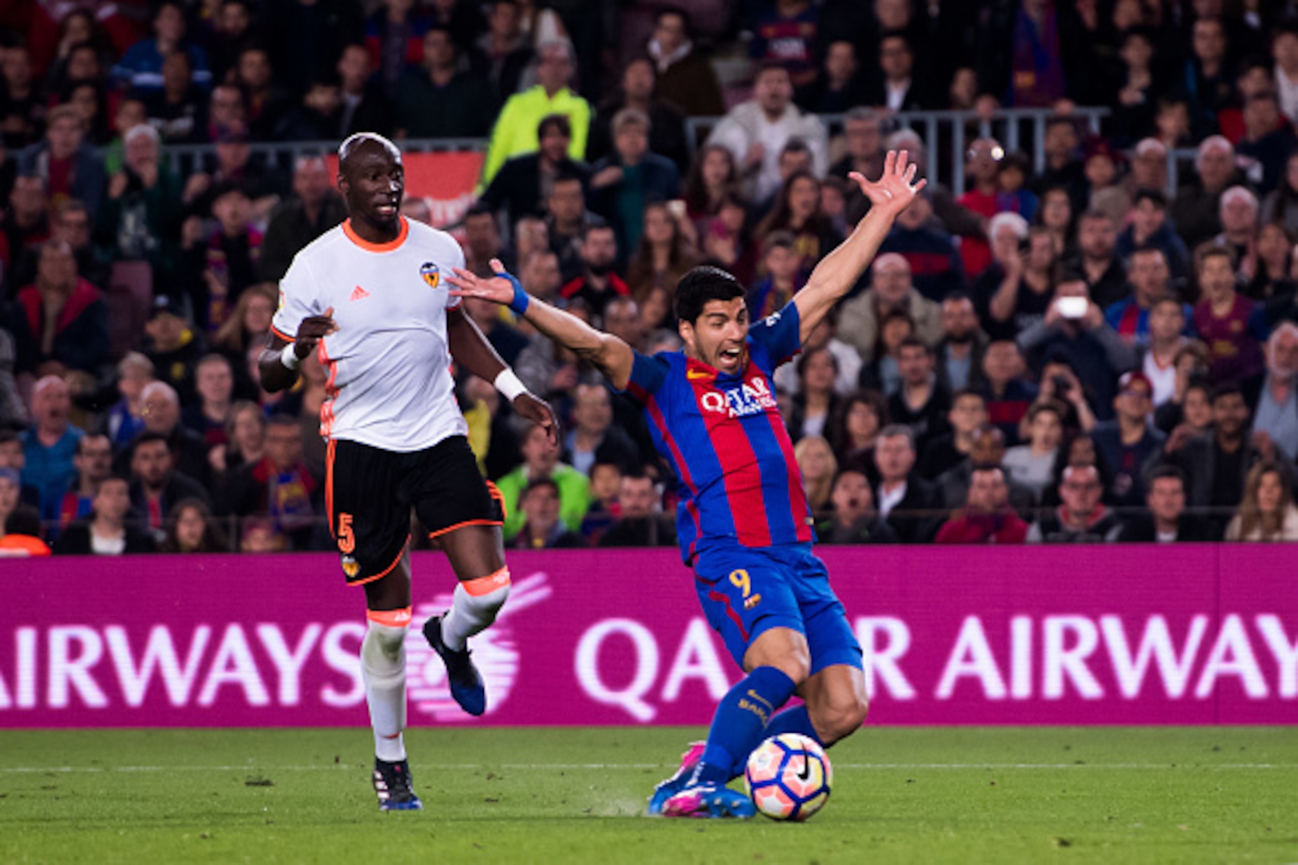 BARCELONA, SPAIN - MARCH 19:  Luis Suarez of FC Barcelona falls after being fouled by Eliaquim Mangala (L) of Valencia CF during the La Liga match between FC Barcelona and Valencia CF at Camp Nou stadium on March 19, 2017 in Barcelona, Spain.  (Photo by A