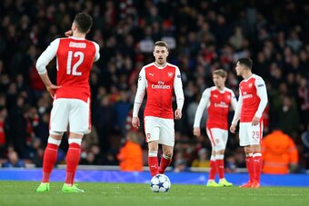 LONDON, ENGLAND - MARCH 07: Aaron Ramsey of Arsenal stands dejected with his team mates during the UEFA Champions League Round of 16 second leg match between Arsenal FC and FC Bayern Muenchen at Emirates Stadium on March 7, 2017 in London, United Kingdom.