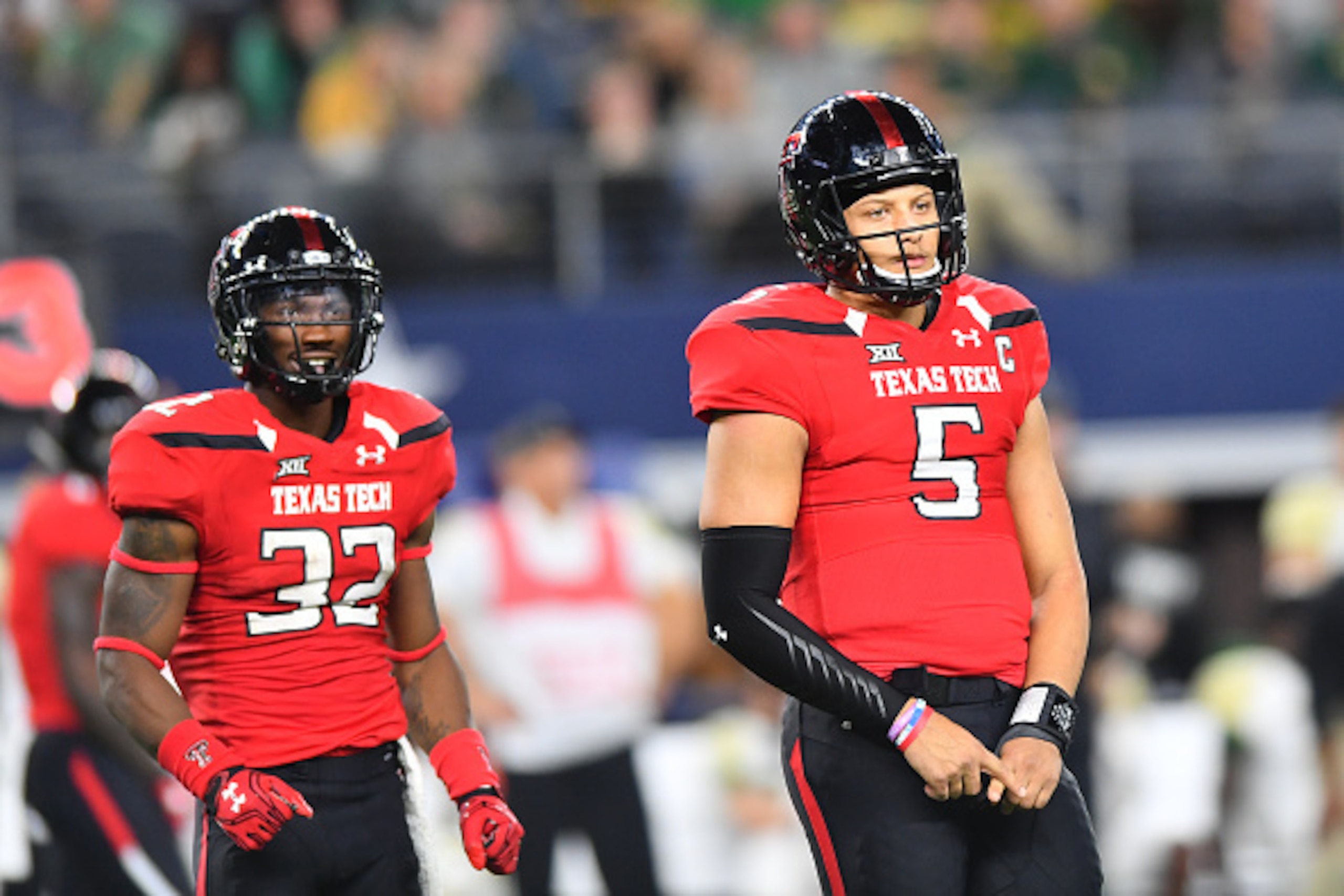 ARLINGTON, TX - NOVEMBER 25: Patrick Mahomes II #5 of the Texas Tech Red Raiders and Da'Leon Ward #32 of the Texas Tech Red Raiders get signals from the bench during the game against the Baylor Bears on November 25, 2016 at AT&T Stadium in Arlington, Texa