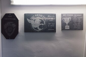 Plaques chart the history of football in Venice.