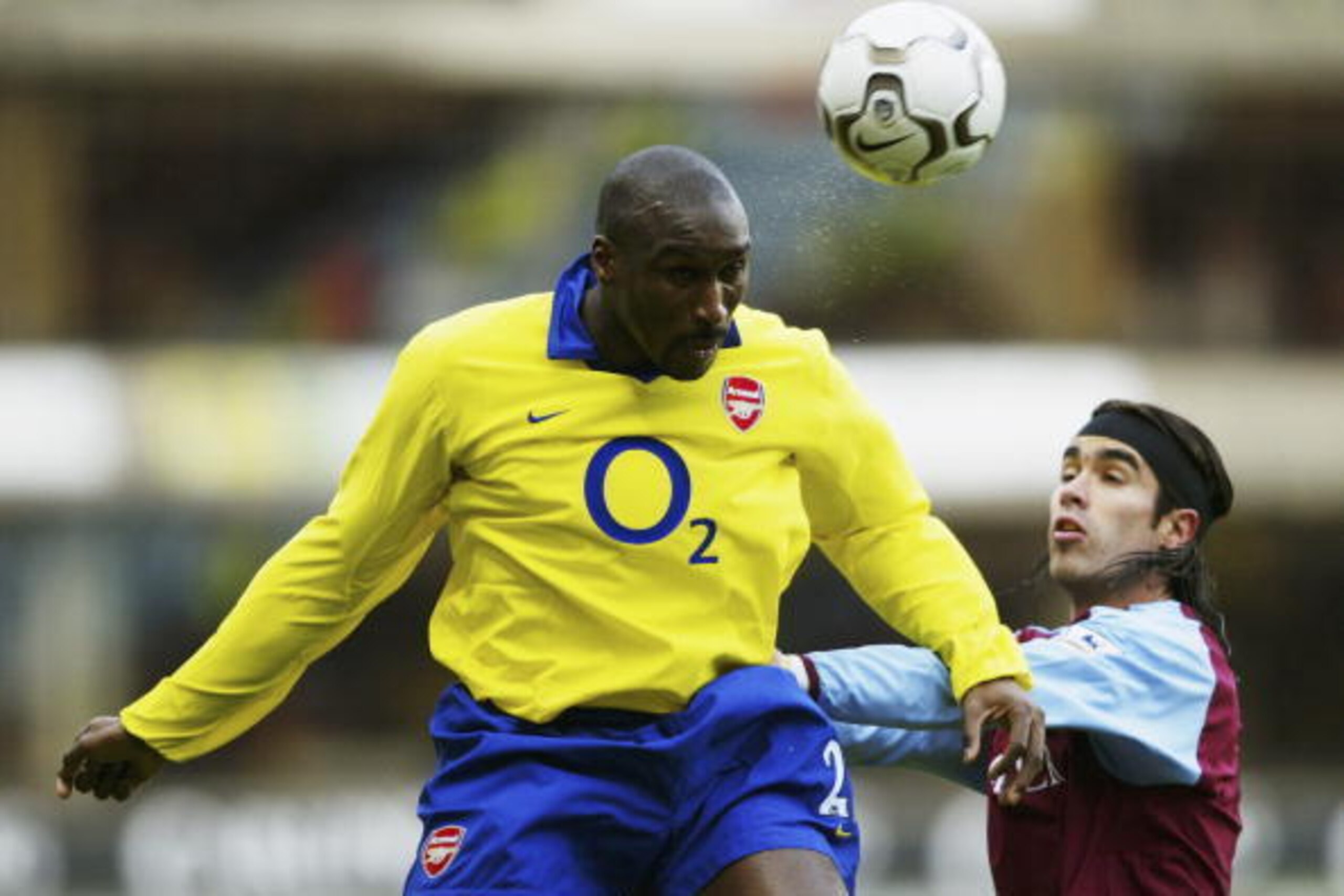 BIRMINGHAM, ENGLAND - JANUARY 18:  Juan Pablo Angel of Aston Villa and Sol Campbell  jump for ball during the FA Barclaycard Premiership match between Aston Villa and Arsenal at Villa Park on January 18, 2004 in Birmingham, England.  (Photo by Shaun Botte