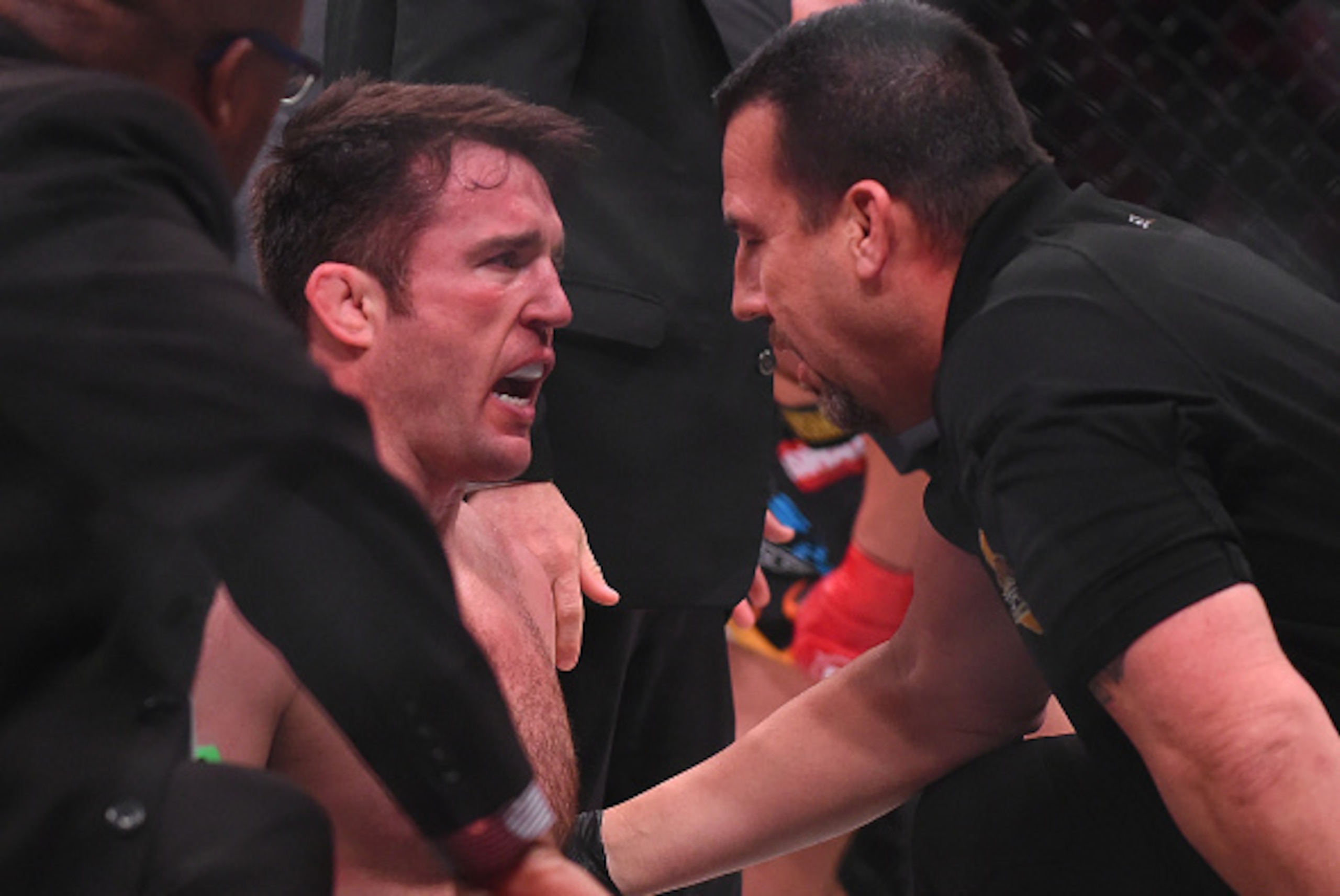 INGLEWOOD, CA - JANUARY 21:  Referee John McCarthy checks on Chael Sonnen (blue gloves) after stopping of his Bellator MMA light heavyweight fight against Tito Ortiz (not pictured) in round one of at The Forum on January 21, 2017 in Inglewood, California.