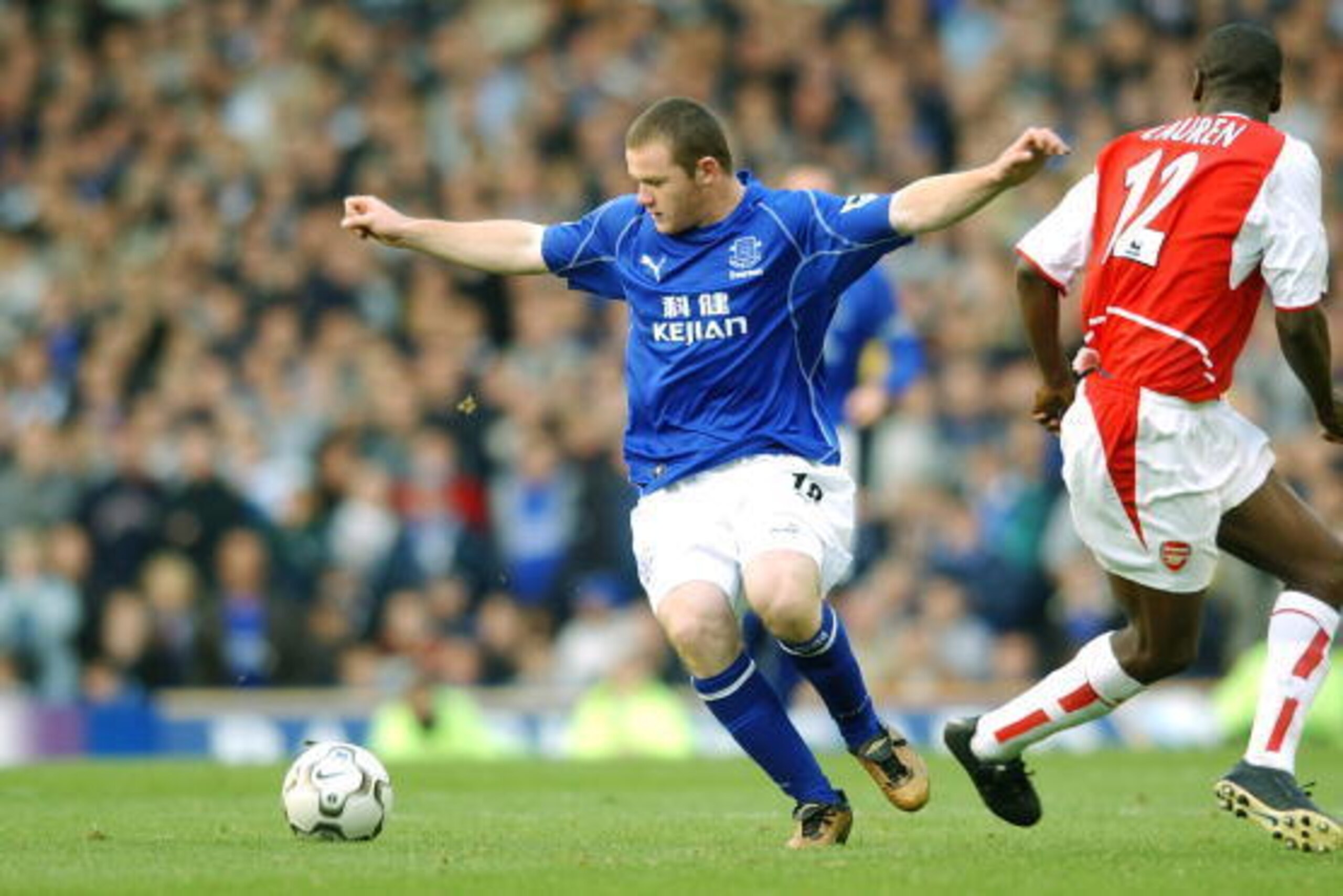 LIVERPOOL - 19 OCTOBER:  Wayne Rooney of Everton takes on Lauren of Arsenal during the FA Barclaycard Premiership match between Everton and Arsenal at Goodison Park in Liverpool on October 19, 2002. Everton won 2-1. (photo by Shaun Botterill/Getty Images.