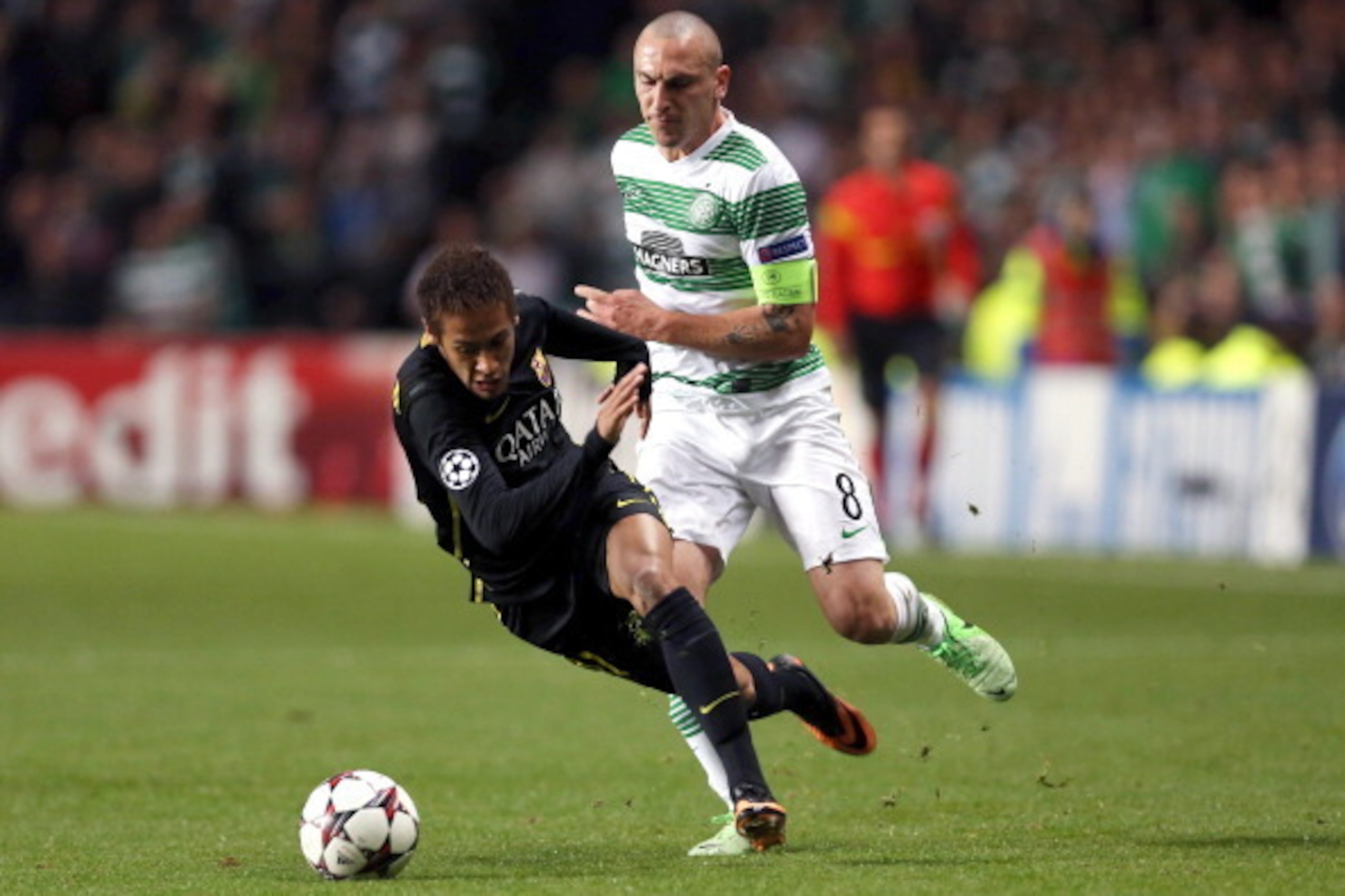 Barcelona's Brazilian striker Neymar (L) is challenged by Celtic's Scottish midfielder Scott Brown before the latter was red carded during their UEFA Champions League Group H football match between Celtic and Barcelona at Celtic Park in Glasgow on October