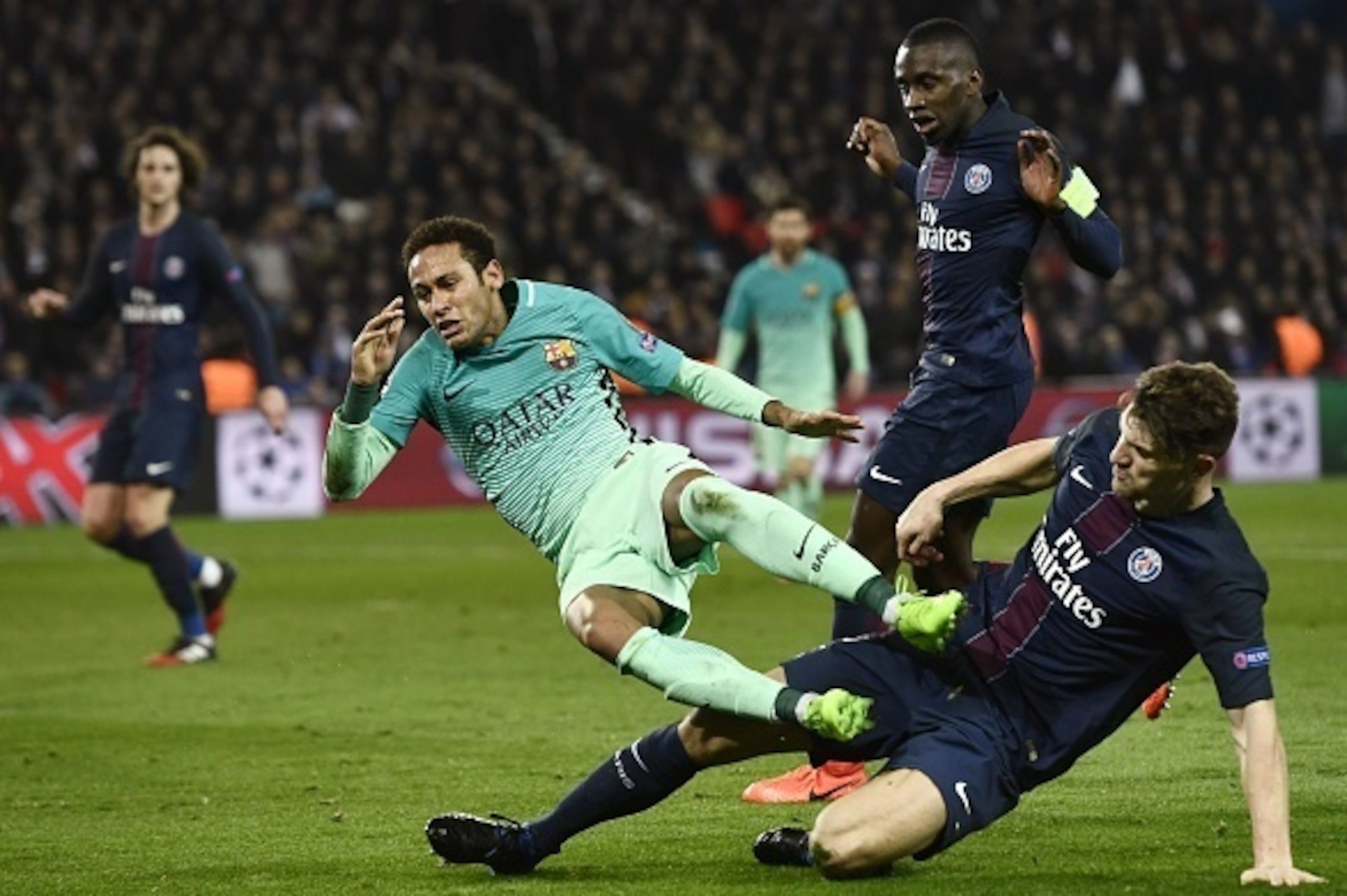 Barcelona's Brazilian forward Neymar is tackled by Paris Saint-Germain's Belgian defender Thomas Meunier during the UEFA Champions League round of 16 first leg football match between Paris Saint-Germain and FC Barcelona on February 14, 2017 at the Parc de