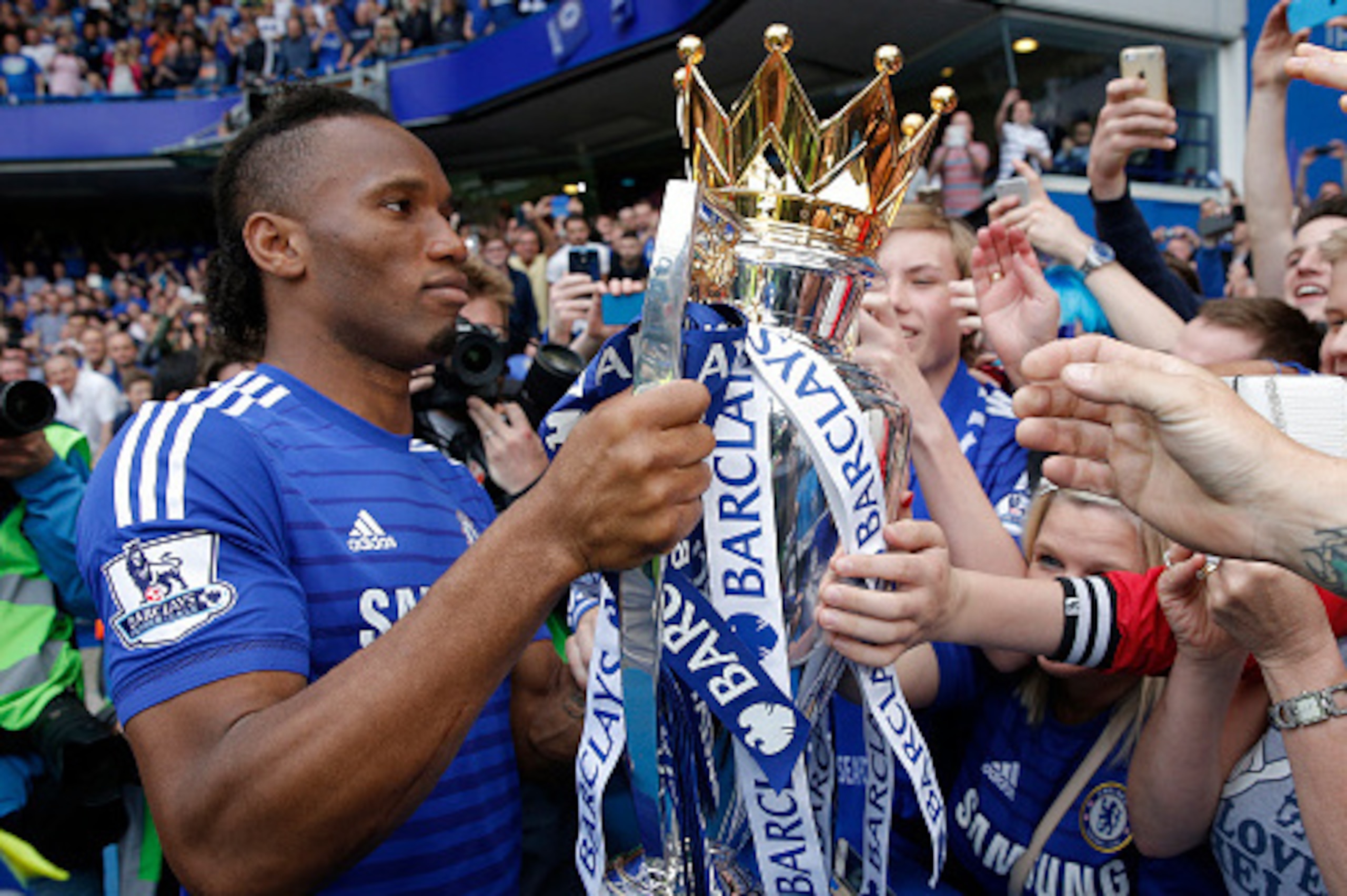 Didier Drogba shows off the Premier League trophy after the game during the Chelsea v Sunderland F.A. Premier League match at Stamford Bridge on May 24th 2015 in London (Photo by Tom Jenkins/Getty Images)