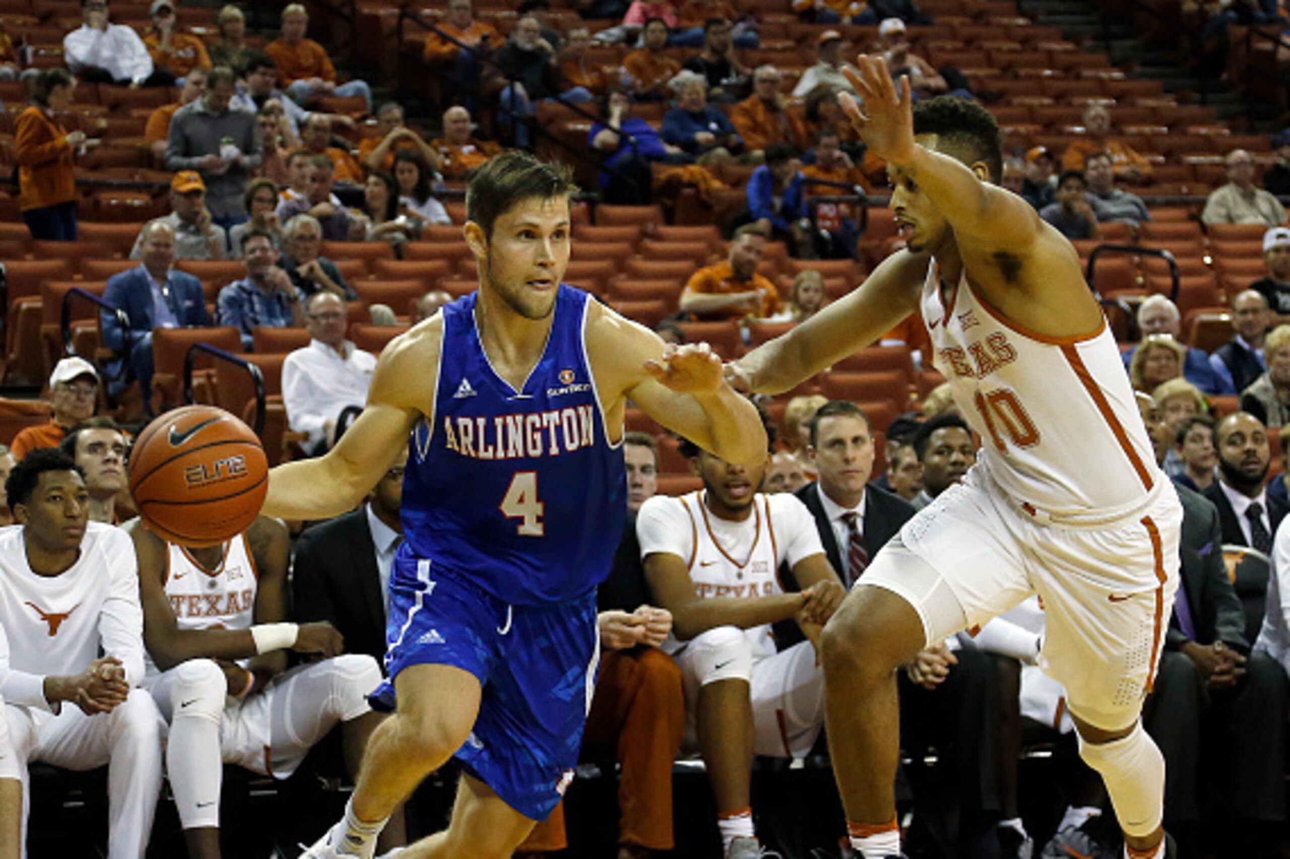 AUSTIN, TX - NOVEMBER 29: Drew Charles #4 of the Texas-Arlington Mavericks drives around Eric Davis Jr. #10 of the Texas Longhorns at the Frank Erwin Center on November 29, 2016 in Austin, Texas. (Photo by Chris Covatta/Getty Images)