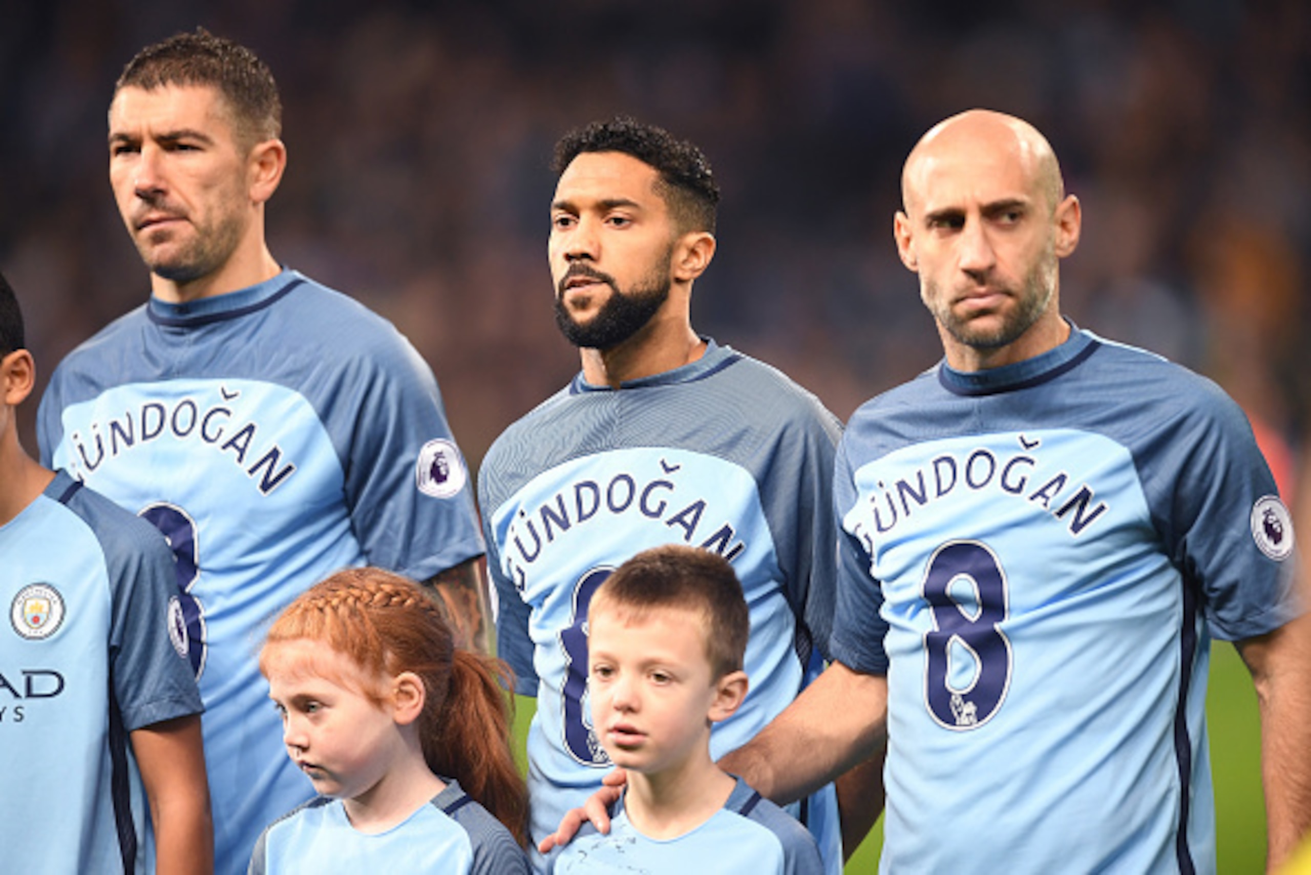 MANCHESTER, ENGLAND - DECEMBER 18: Gael Clichy of Manchester City  and his Manchester City team mates wear Ilkay Gundogan of Manchester City shirt in surport for him after he was injured during the Premier League match between Manchester City and Arsenal 