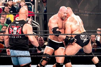 Referee Steve Austin watches on as Goldberg smashes into Brock Lesnar.