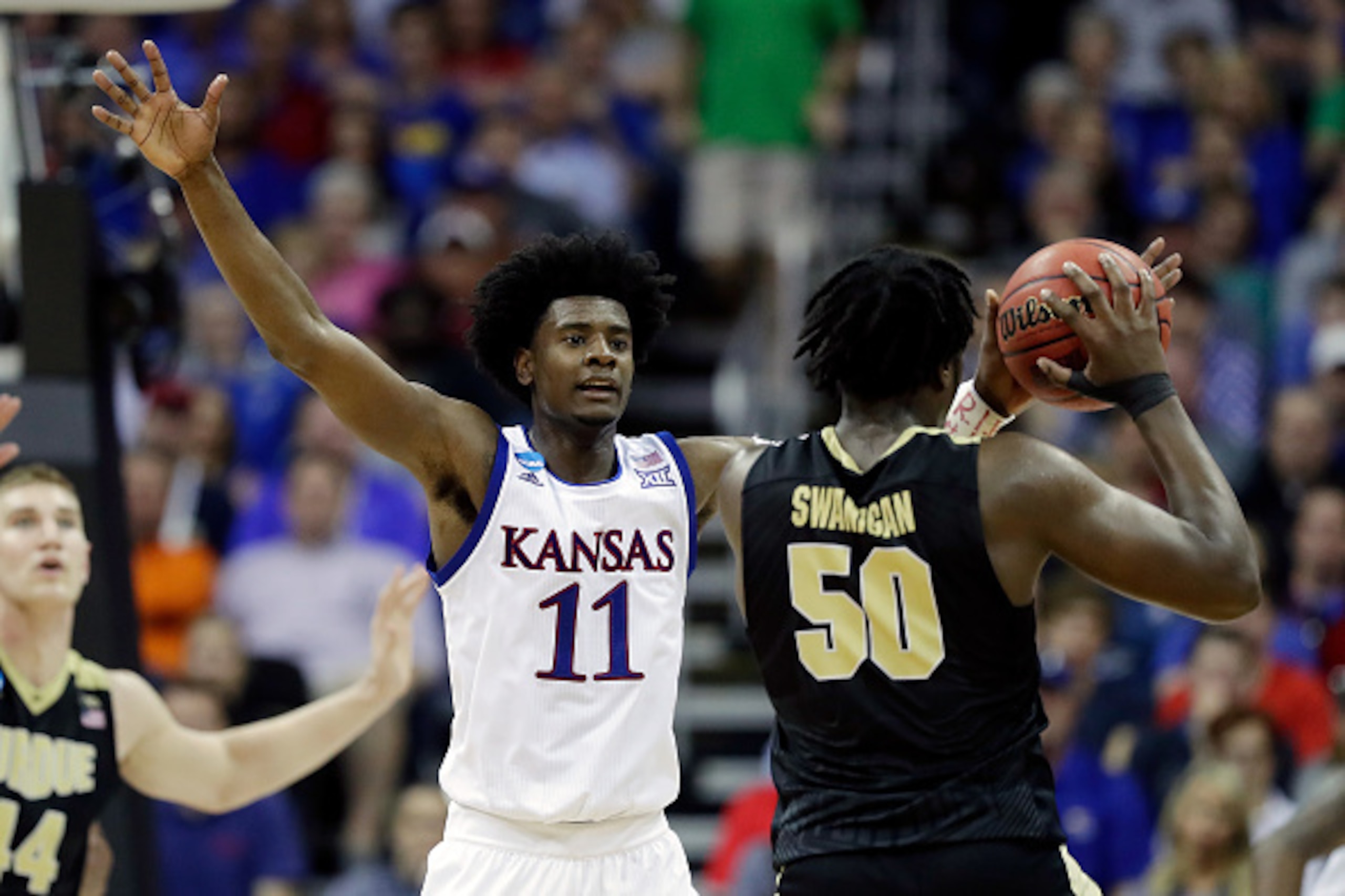 KANSAS CITY, MO - MARCH 23: Caleb Swanigan #50 of the Purdue Boilermakers is defended by Josh Jackson #11 of the Kansas Jayhawks during the 2017 NCAA Men's Basketball Tournament Midwest Regional at Sprint Center on March 23, 2017 in Kansas City, Missouri.