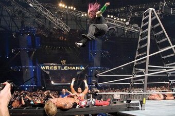 Jimmy Korderas stands at ringside as Jeff Hardy dives on to Edge at WrestleMania 23.