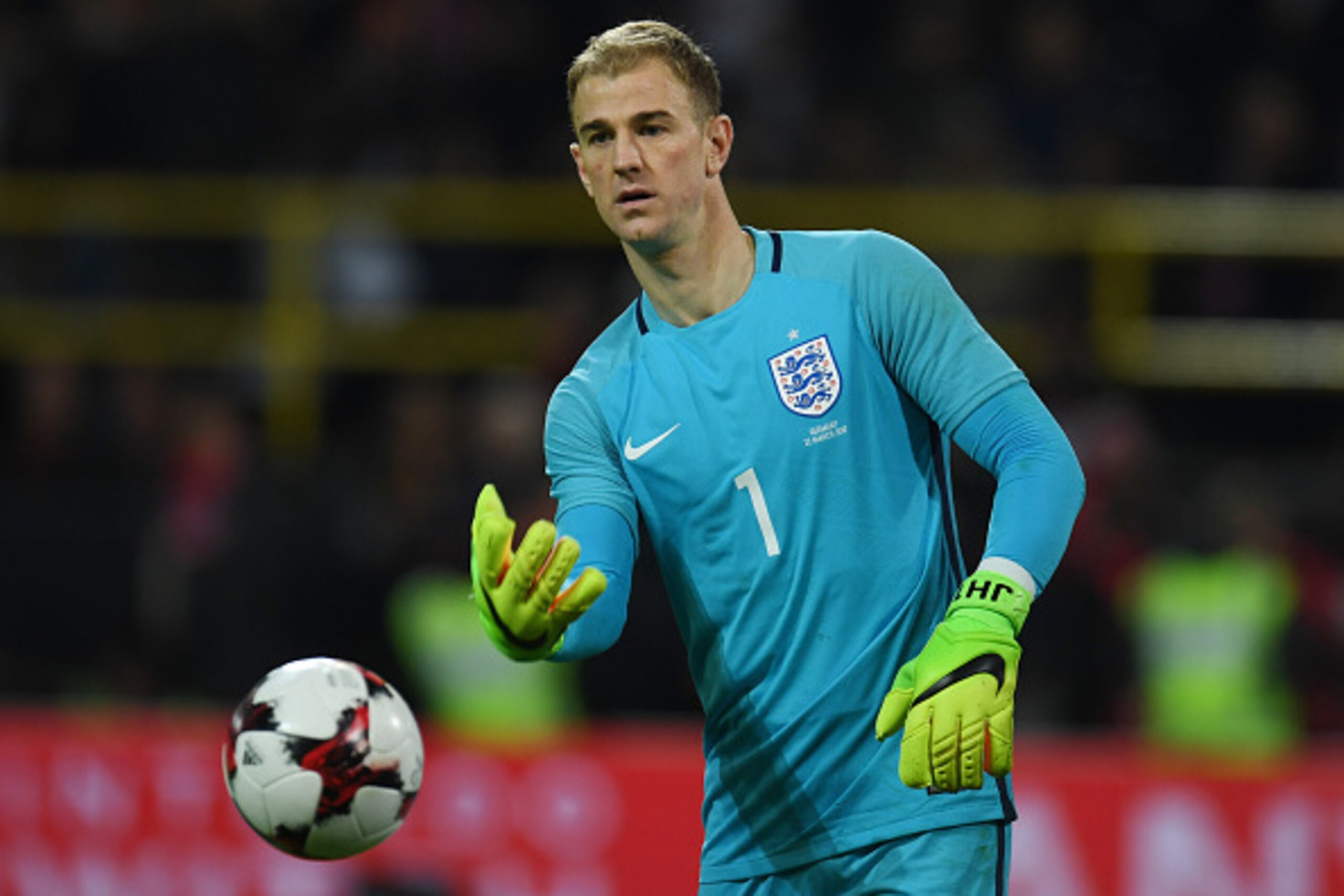 England´s Joe Hart plays the ball during a friendly football match between Germany and England on March 22, 2017 in Dortmund, western Germany. 
It is Lukas Podolski's last match with the German team. / AFP PHOTO / PATRIK STOLLARZ        (Photo credit shou