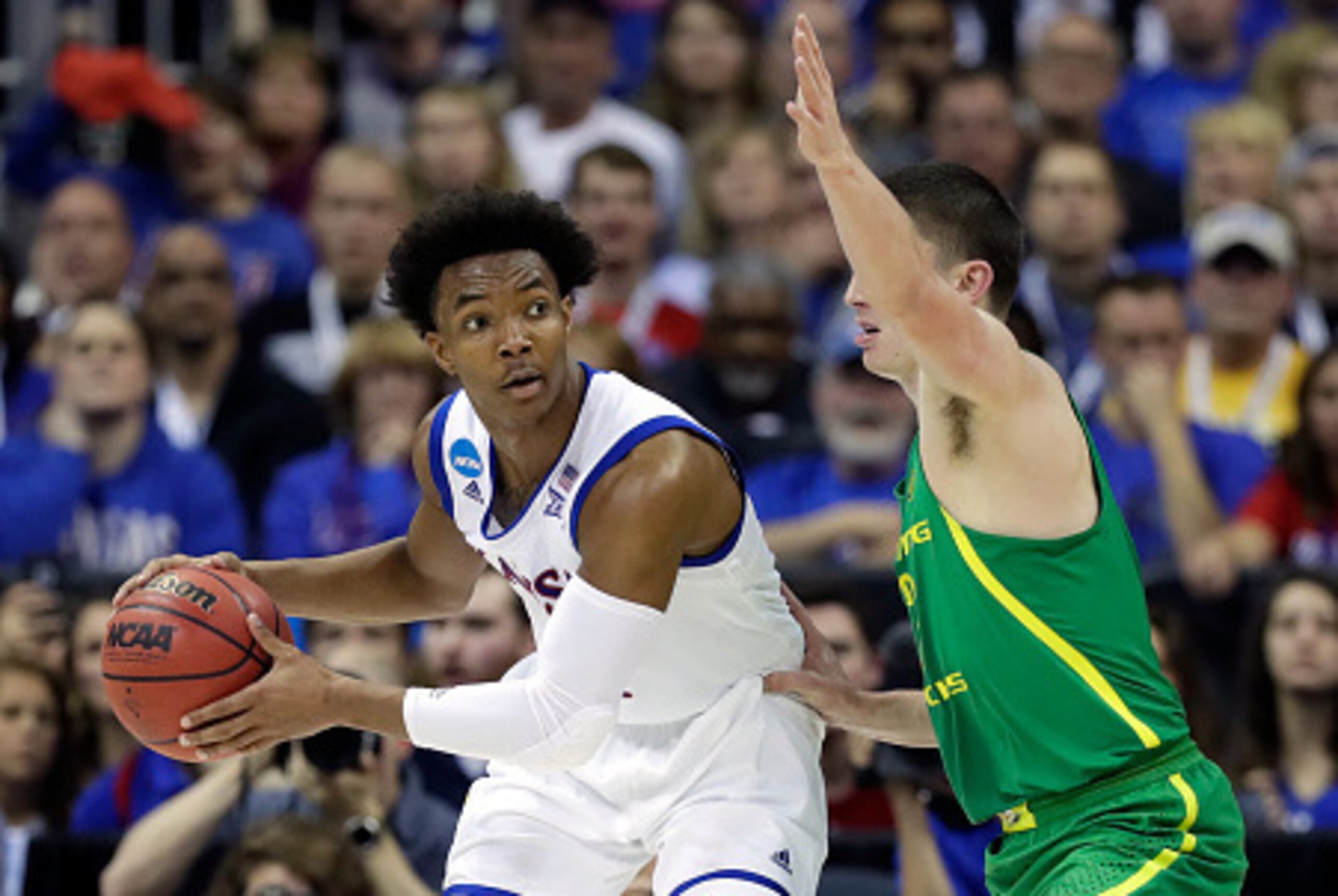 KANSAS CITY, MO - MARCH 25: Devonte' Graham #4 of the Kansas Jayhawks handles the ball against the Oregon Ducks during the 2017 NCAA Men's Basketball Tournament Midwest Regional at Sprint Center on March 25, 2017 in Kansas City, Missouri. (Photo by Jami KANSAS CITY, MO - MARCH 25: Devonte' Graham #4 of the Kansas Jayhawks handles the ball against the Oregon Ducks during the 2017 NCAA Men's Basketball Tournament Midwest Regional at Sprint Center on March 25, 2017 in Kansas City, Missouri. (Photo by Jami