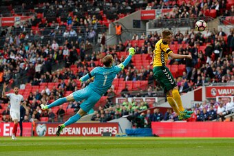 England's goalkeeper Joe Hart (L) vies for the ball with Lithuania's midfielder Vykintas Slivka during the World Cup 2018 qualification football match between England and Lithuania at Wembley Stadium in London on March 26, 2017.  / AFP PHOTO / Adrian DENN