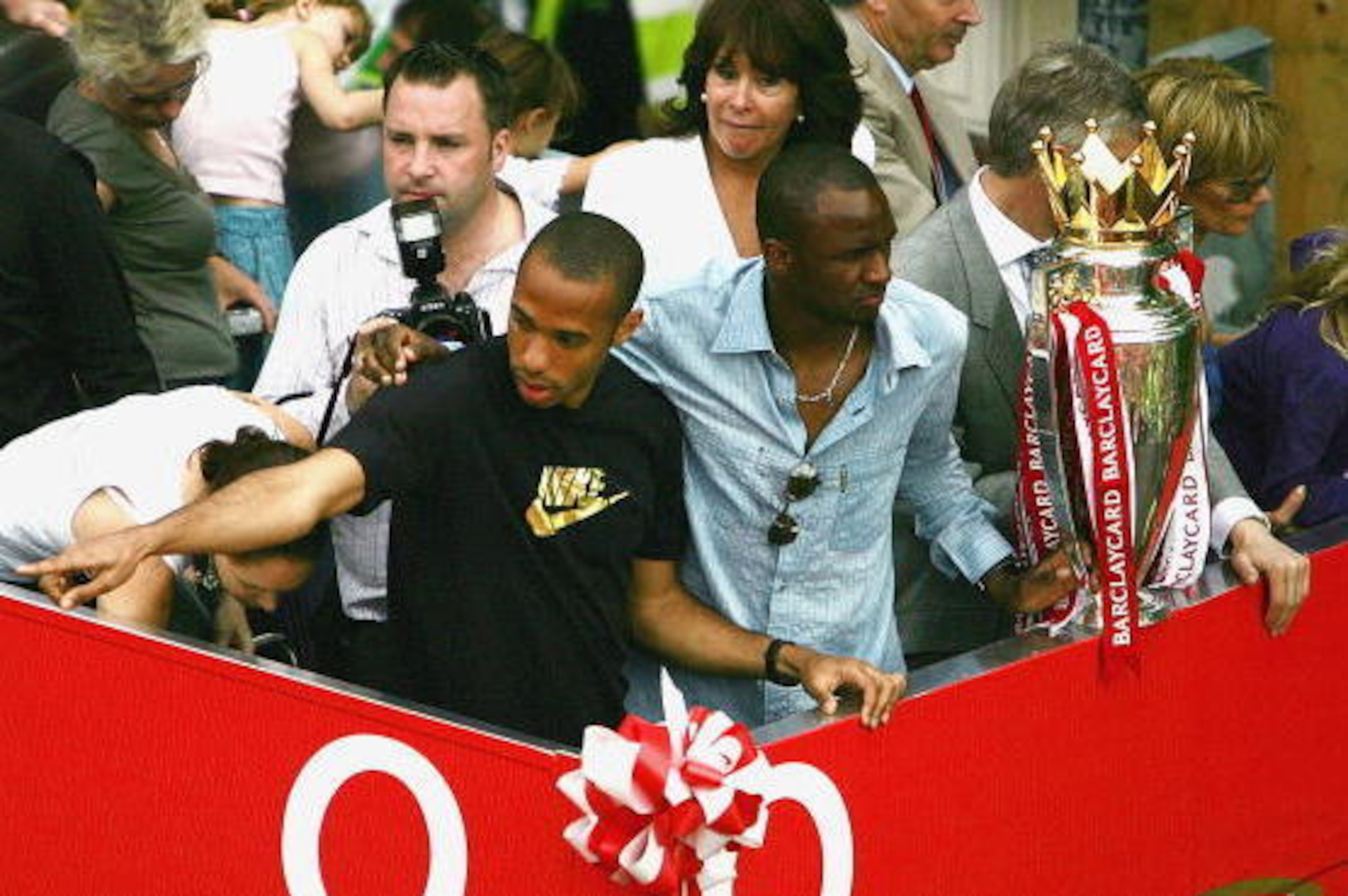 LONDON - MAY 16:  Thierry Henry (L) and Patrick Vieira are seen at the front of the bus outside the Islington Town Hall during the Arsenal Football Club victory parade to show the League Champions with their FA Barclaycard Premiership Trophy on May 16, 20