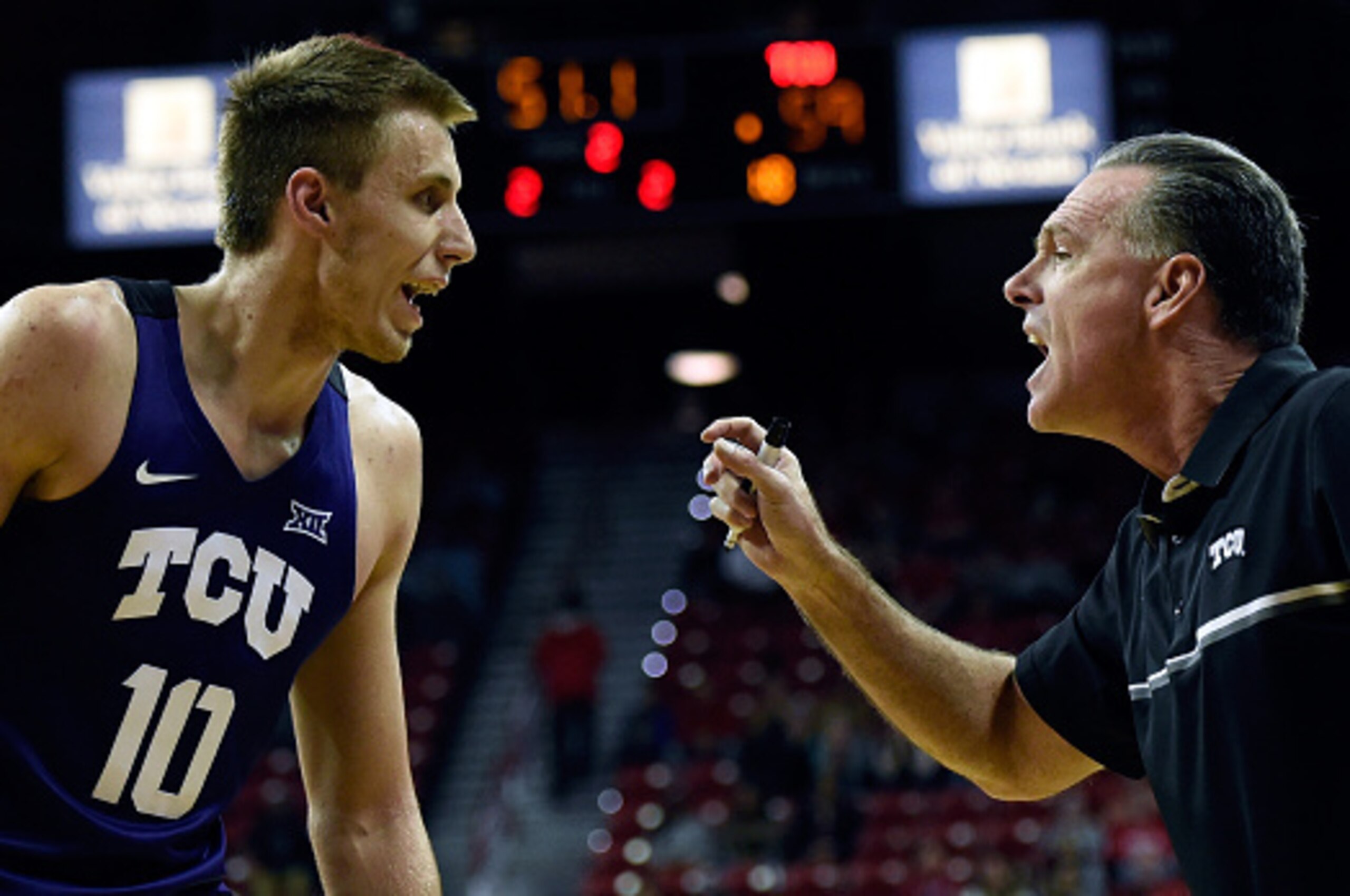 LAS VEGAS, NV - NOVEMBER 25:  Head coach Jamie Dixon of the Texas Christian University Horned Frogs speaks with his player Vladimir Brodziansky #10 during a game against the UNLV Rebels during the Global Sports Classic basketball tournament at the Thomas 
