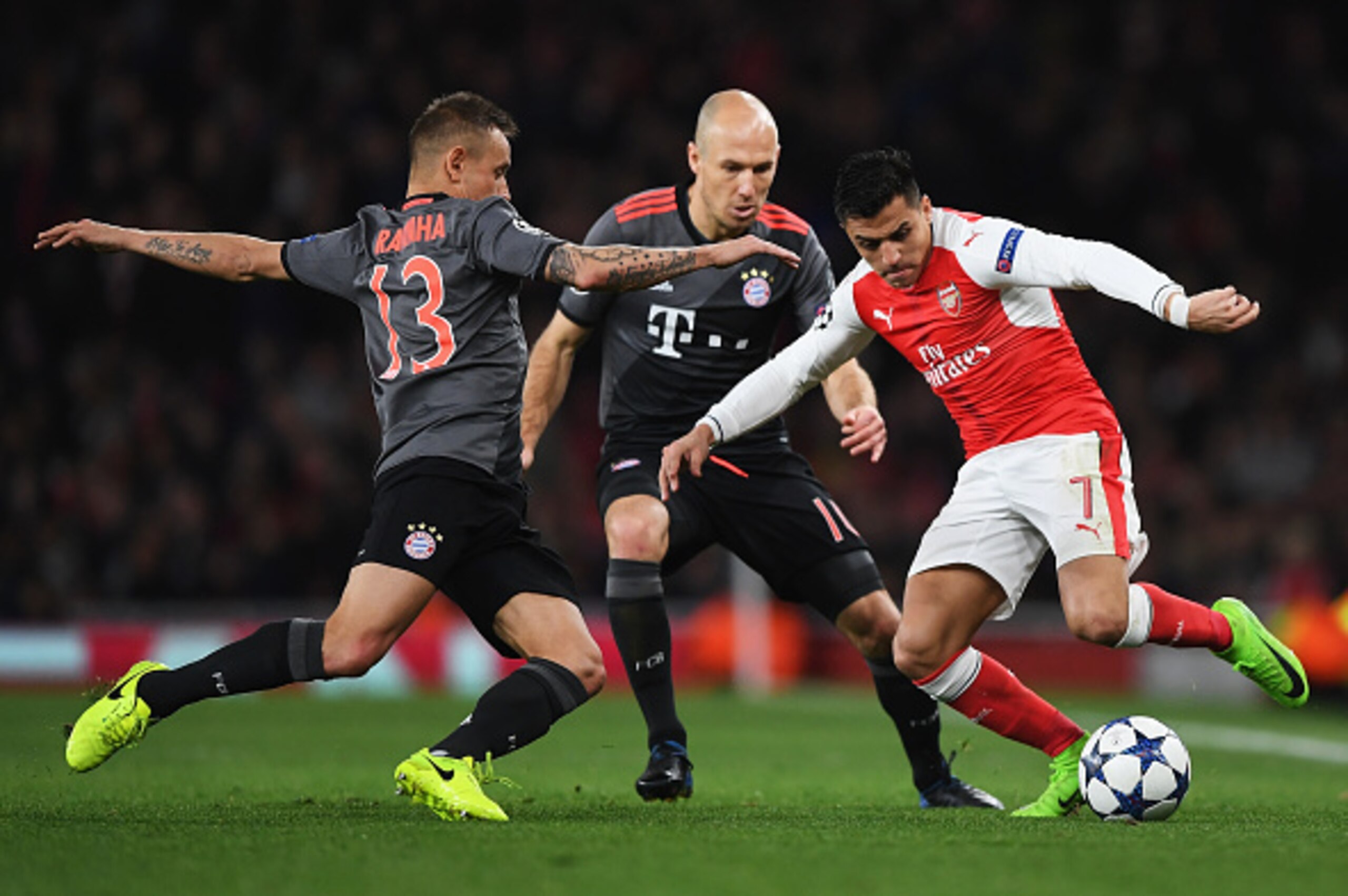 LONDON, ENGLAND - MARCH 07:  Alexis Sanchez of Arsenal battles with Rafinha (13) and Arjen Robben of Bayern Muenchen during the UEFA Champions League Round of 16 second leg match between Arsenal FC and FC Bayern Muenchen at Emirates Stadium on March 7, 20