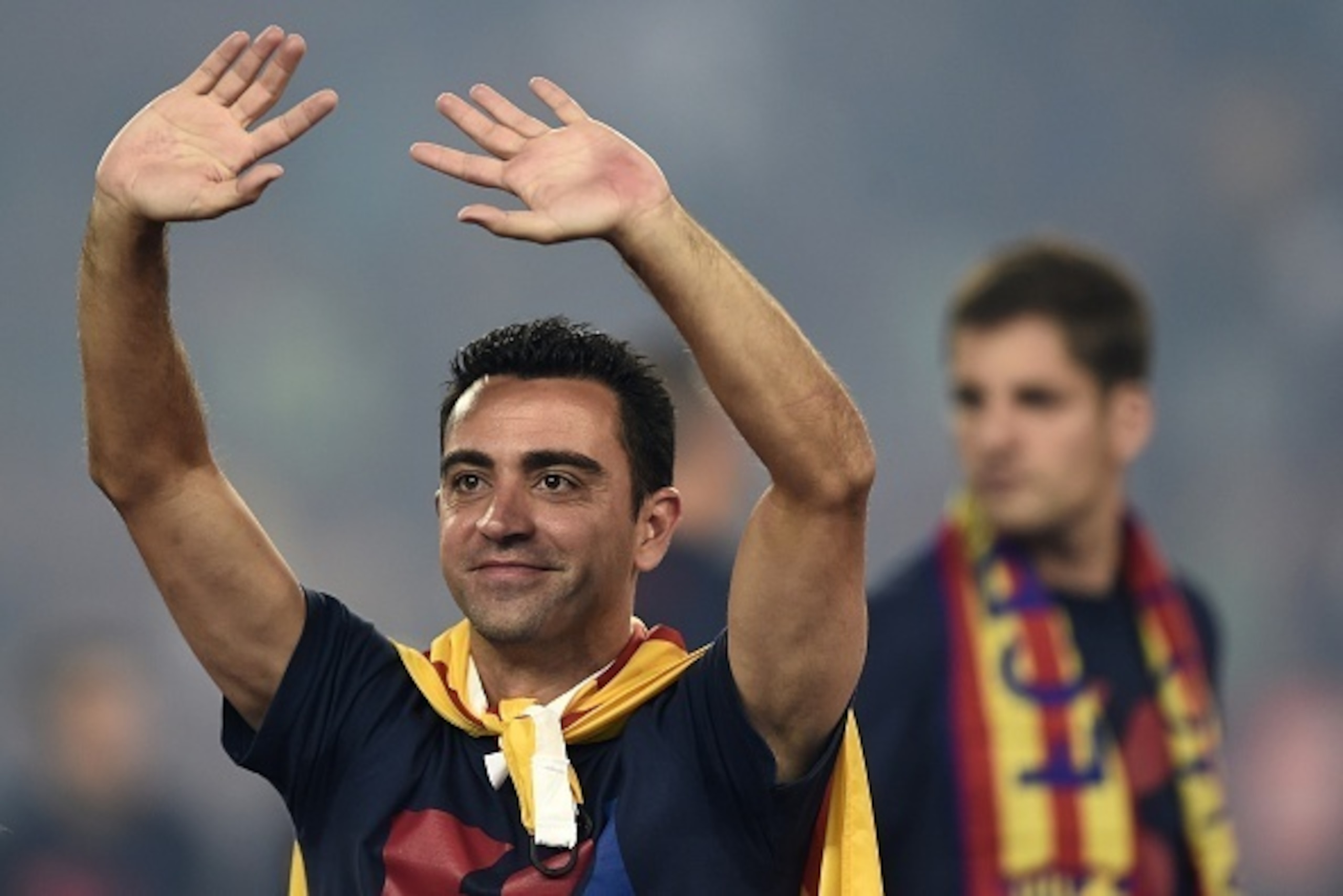 Barcelona's midfielder Xavi Hernandez waves as he takes part in the celebrations held for their victory over Juventus, one day after the UEFA Champions League final football, at the Camp Nou stadium in Barcelona on June 7, 2015. Luis Suarez and Neymar sco