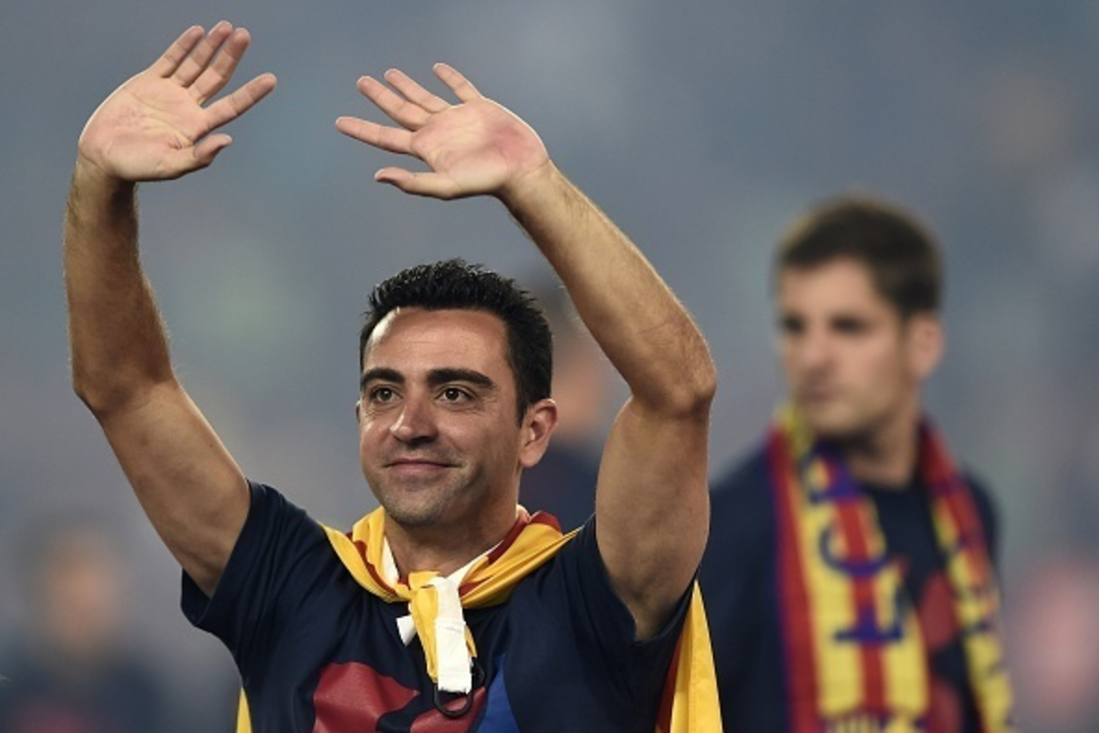 Barcelona's midfielder Xavi Hernandez waves as he takes part in the celebrations held for their victory over Juventus, one day after the UEFA Champions League final football, at the Camp Nou stadium in Barcelona on June 7, 2015. Luis Suarez and Neymar sco
