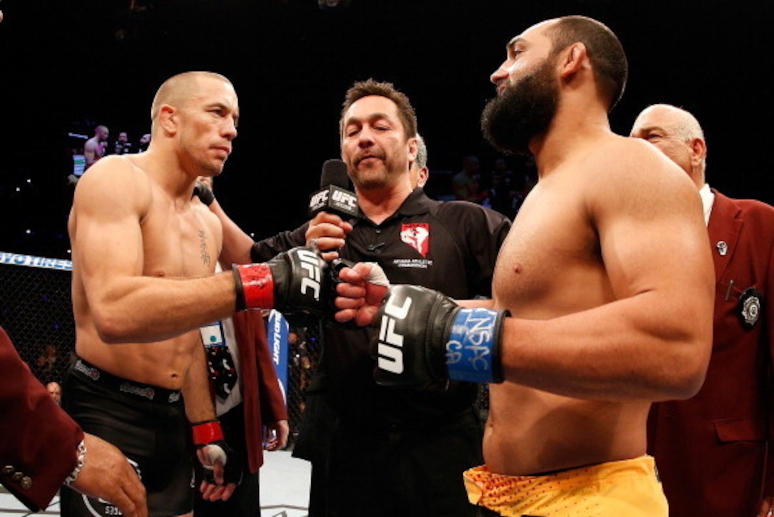 LAS VEGAS, NV - NOVEMBER 16:  (L-R) Georges St-Pierre and Johny Hendricks touch gloves before their UFC welterweight championship bout during the UFC 167 event inside the MGM Grand Garden Arena on November 16, 2013 in Las Vegas, Nevada. (Photo by Josh Hed