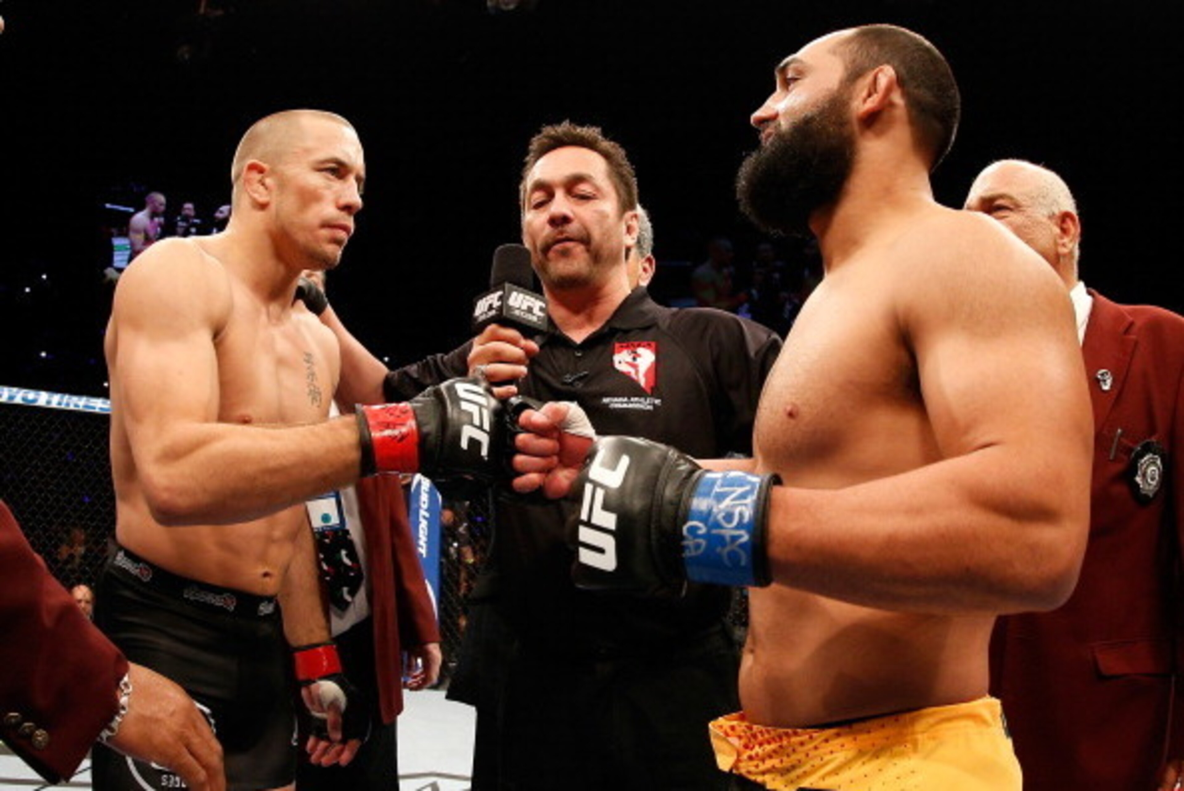 LAS VEGAS, NV - NOVEMBER 16:  (L-R) Georges St-Pierre and Johny Hendricks touch gloves before their UFC welterweight championship bout during the UFC 167 event inside the MGM Grand Garden Arena on November 16, 2013 in Las Vegas, Nevada. (Photo by Josh Hed