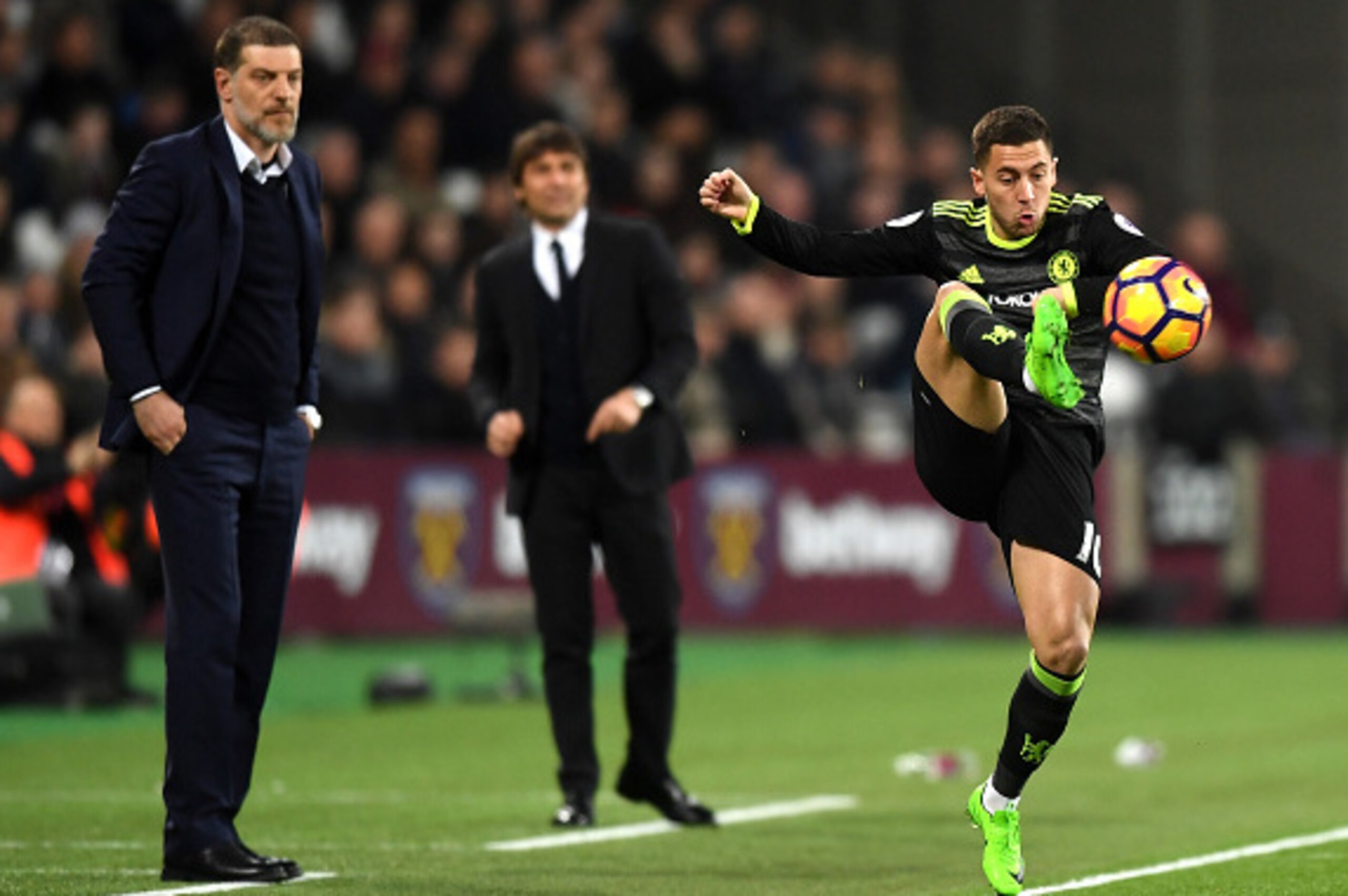 STRATFORD, ENGLAND - MARCH 06:  Slaven Bilic, Manager of West Ham United, and Antonio Conte, Manager of Chelsea watch on as Eden Hazard of Chelsea controlls the ball during the Premier League match between West Ham United and Chelsea at London Stadium on 