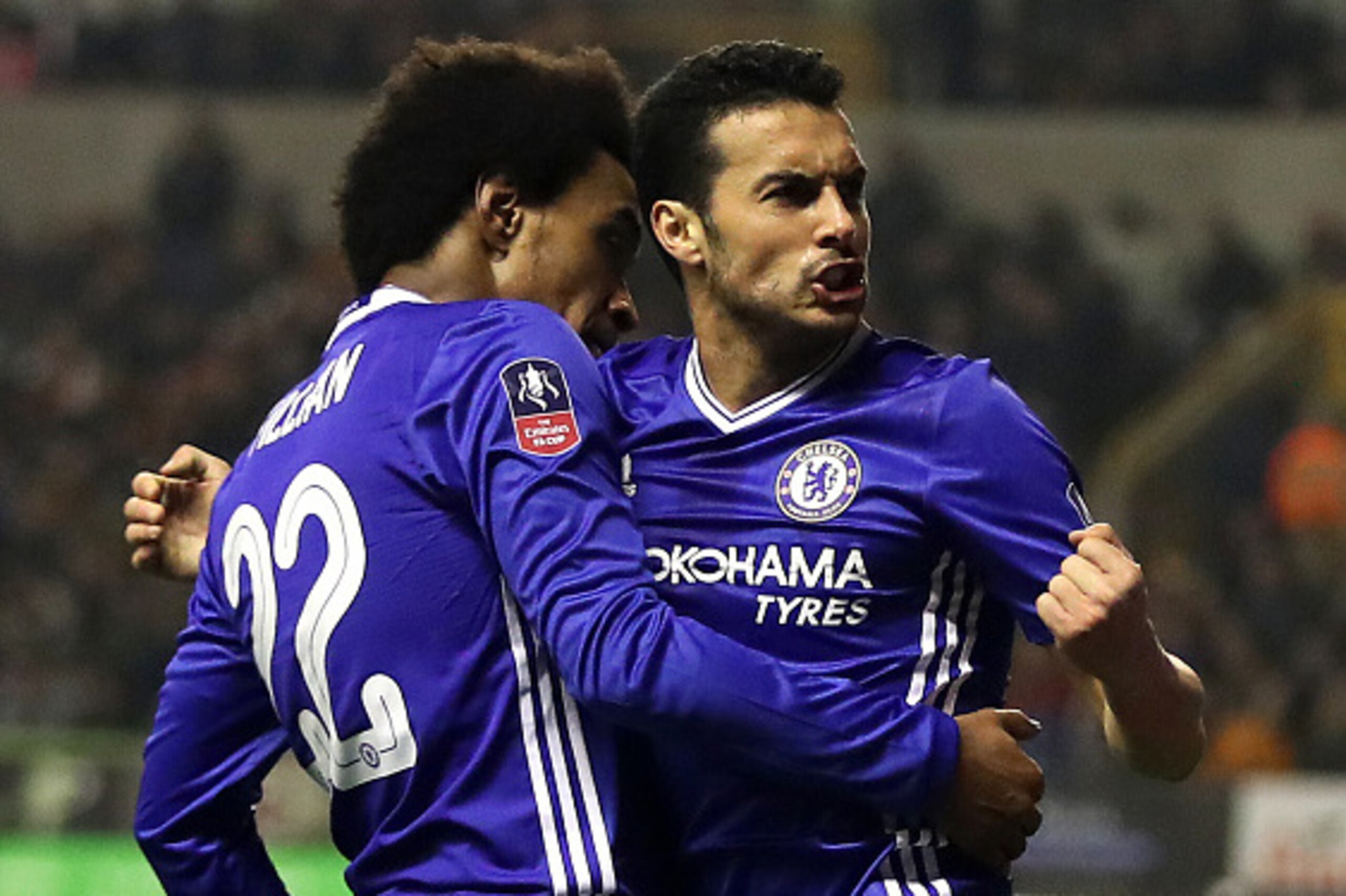 WOLVERHAMPTON, ENGLAND - FEBRUARY 18: Pedro of Chelsea celebrates scoring the opening goal with team-mate Willian during the Emirates FA Cup Fifth Round match between Wolverhampton Wanderers and Chelsea at Molineux on February 18, 2017 in Wolverhampton, E