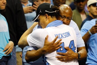 Justin Jackson hugs his father, Lloyd Jackson, after defeating the Kentucky Wildcats during the NCAA tournament South Regional on March 26, 2017.