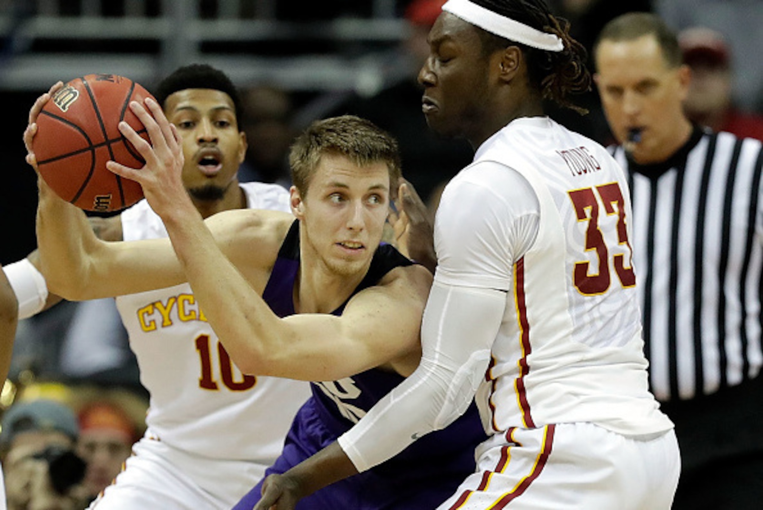 KANSAS CITY, MO - MARCH 10:  Vladimir Brodziansky #10 of the TCU Horned Frogs controls the ball as Darrell Bowie #10 and Solomon Young #33 of the Iowa State Cyclones defend during the semifinal game of the Big 12 Basketball Tournament at Sprint Center on 