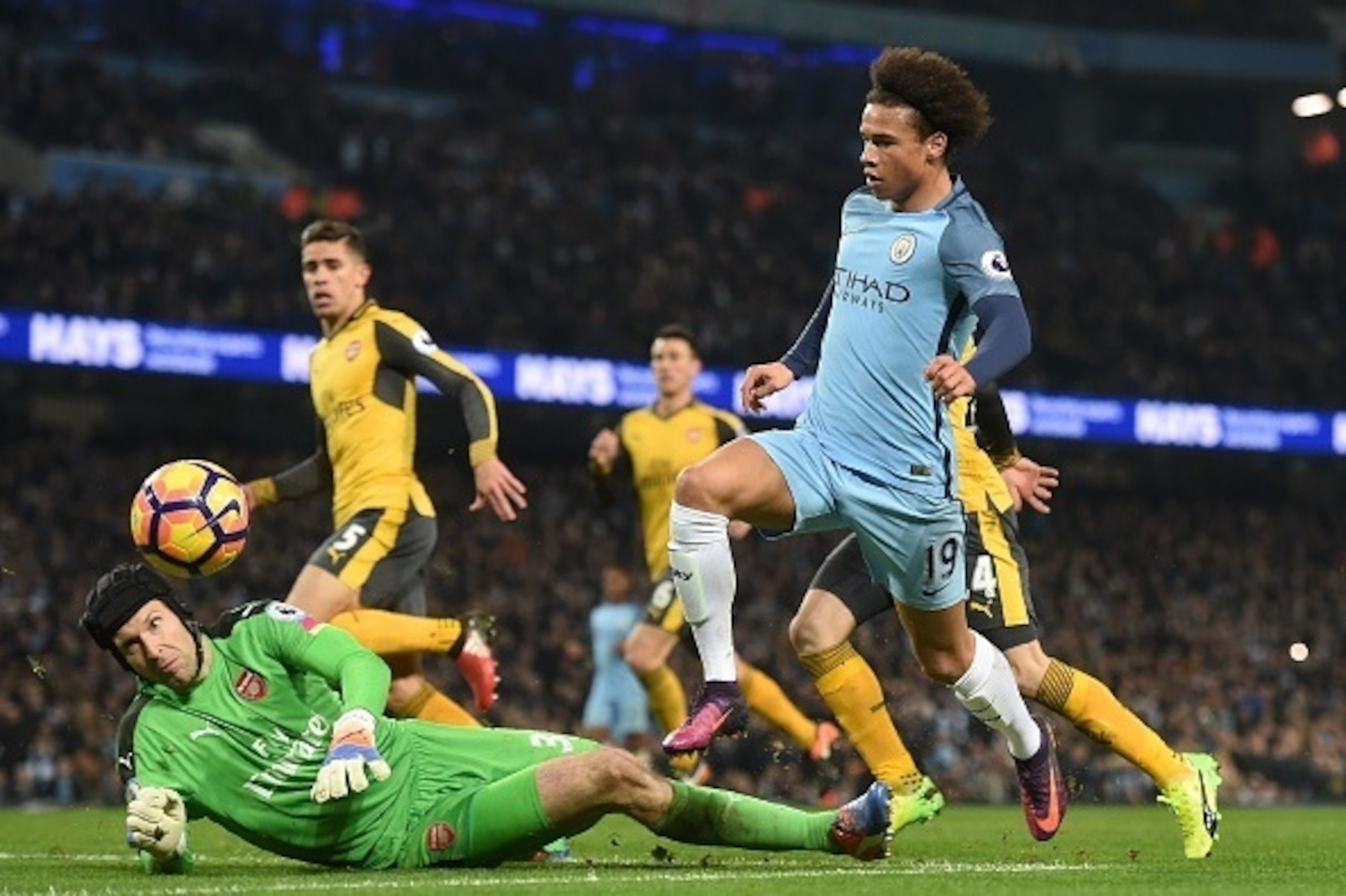 Arsenal's Czech goalkeeper Petr Cech (L) makes a save from Manchester City's German midfielder Leroy Sane during the English Premier League football match between Manchester City and Arsenal at the Etihad Stadium in Manchester, north west England, on Dece