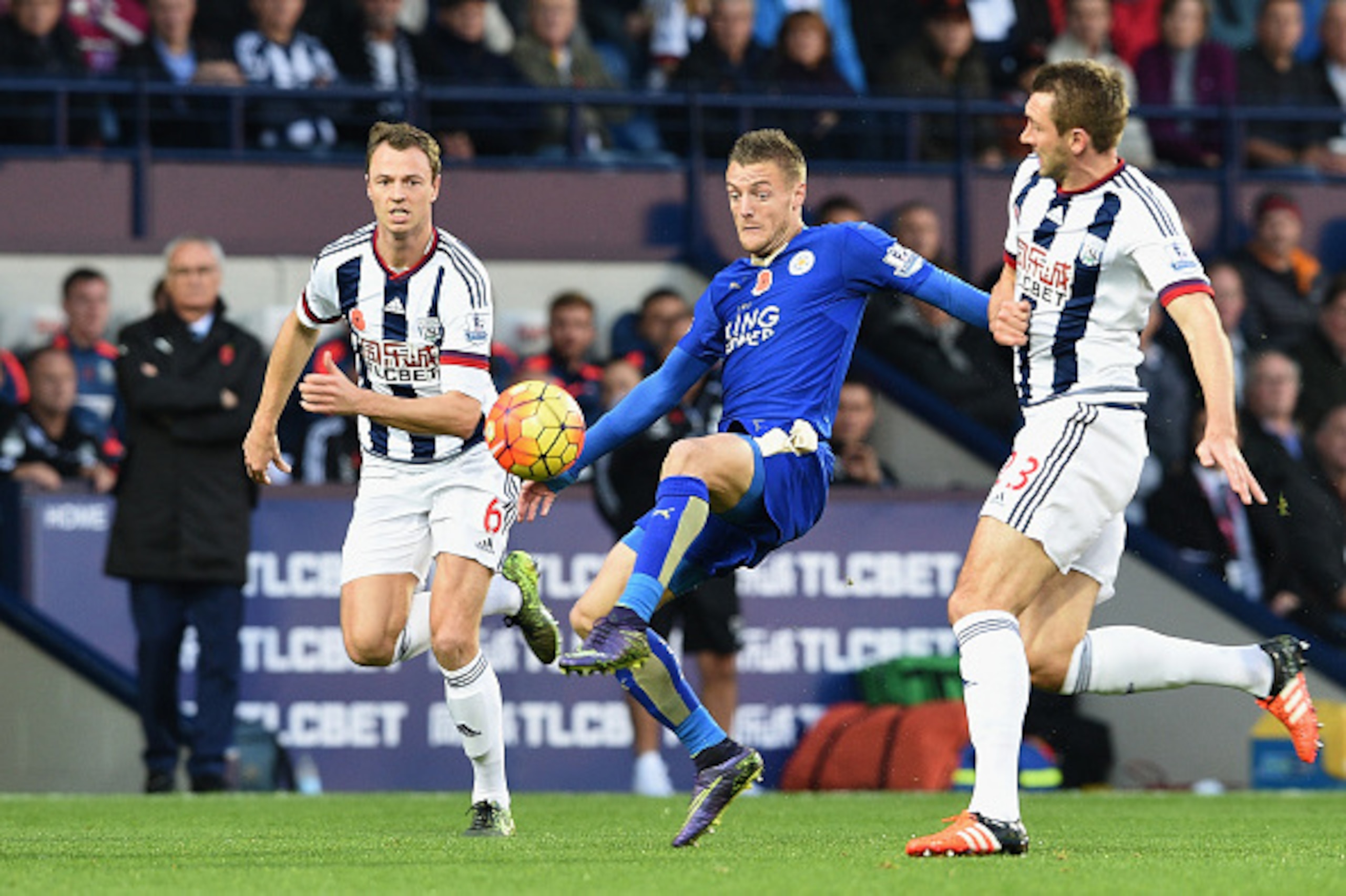 WEST BROMWICH, ENGLAND - OCTOBER 31: Jamie Vardy (C) of Leicester City controls the ball against Jonny Evans (L) and Gareth McAuley (R) of West Bromwich Albion during the Barclays Premier League match between West Bromwich Albion and Leicester City at The