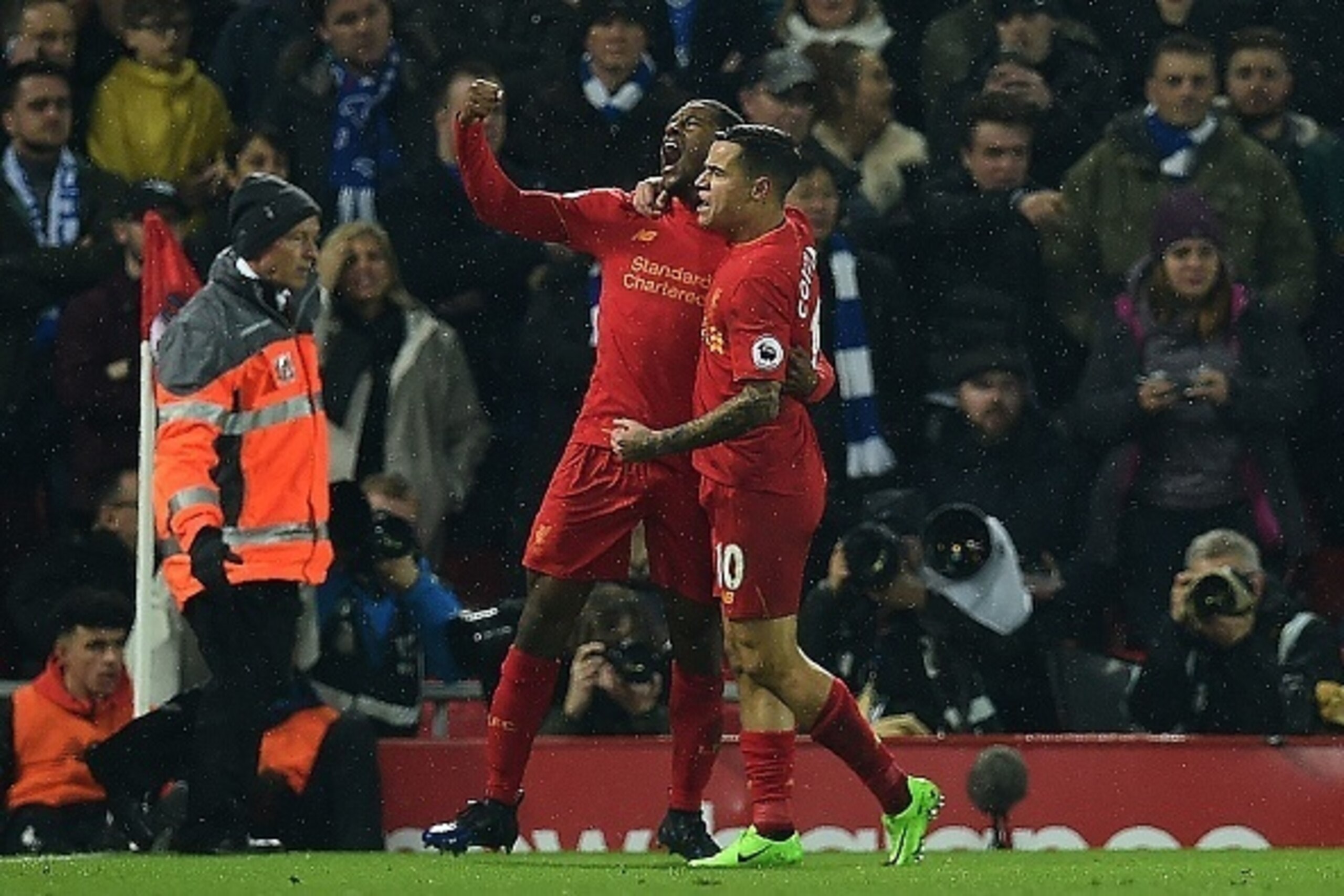 Liverpool's Dutch midfielder Georginio Wijnaldum (L) celebrates scoring his team's first goal with Liverpool's Brazilian midfielder Philippe Coutinho during the English Premier League football match between Liverpool and Chelsea at Anfield in Liverpool, n