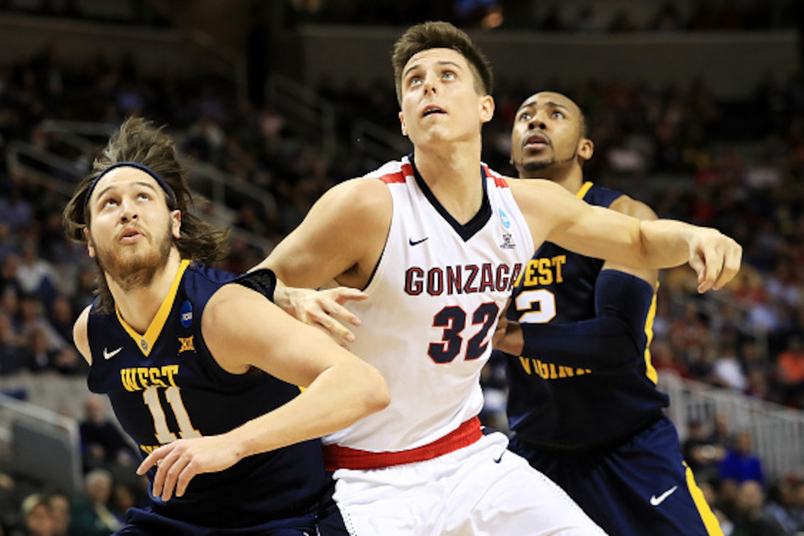 SAN JOSE, CA - MARCH 23: Zach Collins #32 of the Gonzaga Bulldogs vies for position with Nathan Adrian #11 and Jevon Carter #2 of the West Virginia Mountaineers in the first half during the 2017 NCAA Men's Basketball Tournament West Regional at SAP Cente SAN JOSE, CA - MARCH 23: Zach Collins #32 of the Gonzaga Bulldogs vies for position with Nathan Adrian #11 and Jevon Carter #2 of the West Virginia Mountaineers in the first half during the 2017 NCAA Men's Basketball Tournament West Regional at SAP Cente