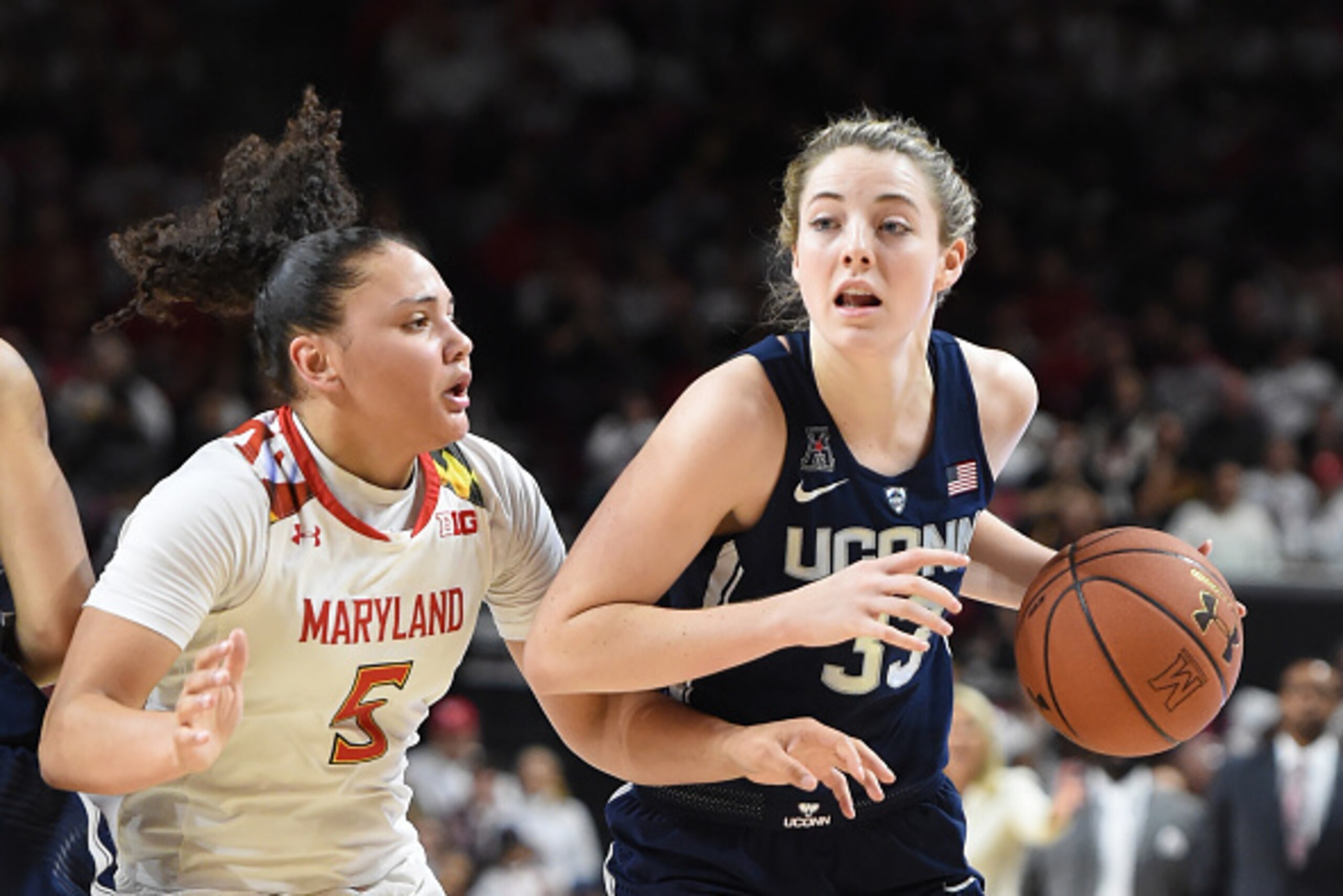 COLLEGE PARK, MD - DECEMBER 29:  Katie Lou Samuelson #33 of the Connecticut Huskies dribbles by Destiny Slocum #5 of the Maryland Terrapins during a women's college basketball game at the XFinity Center on December 29, 2016 in College Park, Maryland.  The