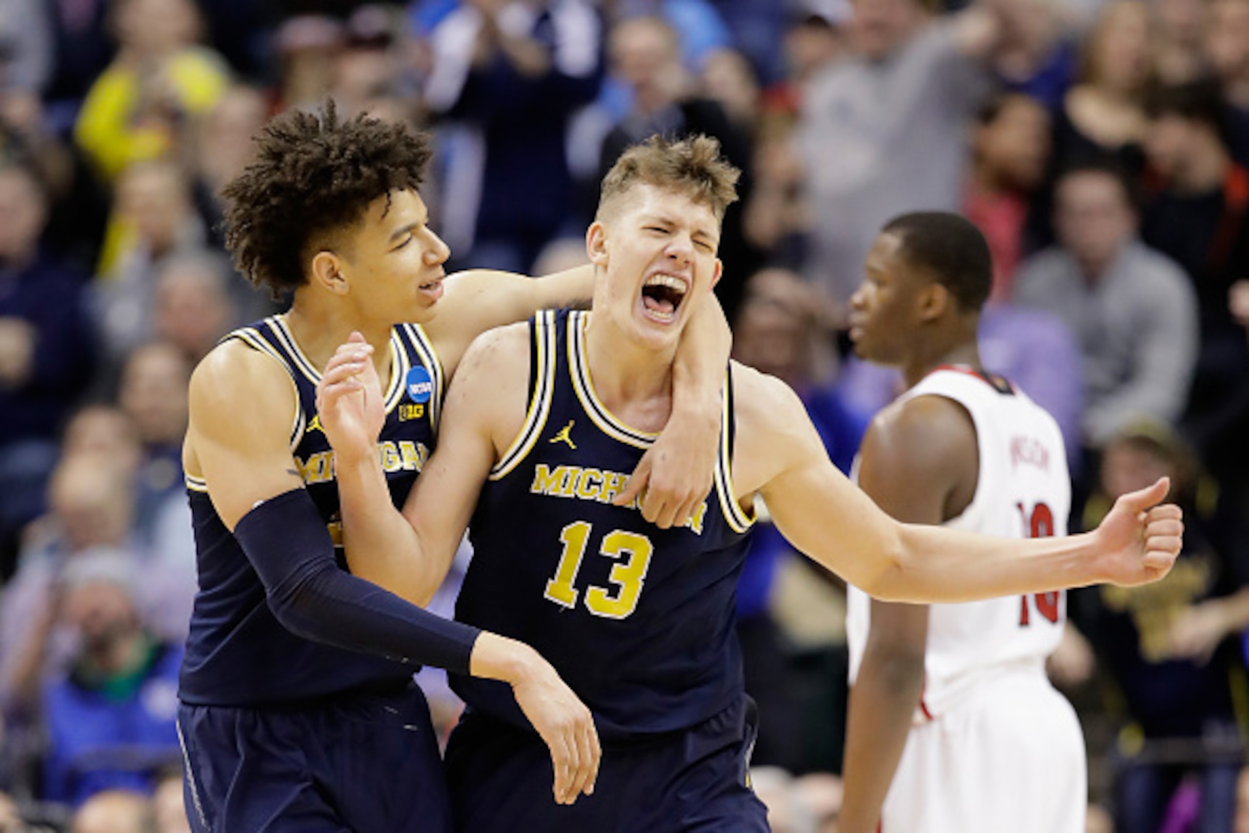 INDIANAPOLIS, IN - MARCH 19:  Moritz Wagner #13 of the Michigan Wolverines celebrates a shot with D.J. Wilson #5 in the second half against the Louisville Cardinals during the second round of the 2017 NCAA Men's Basketball Tournament at the Bankers Life F